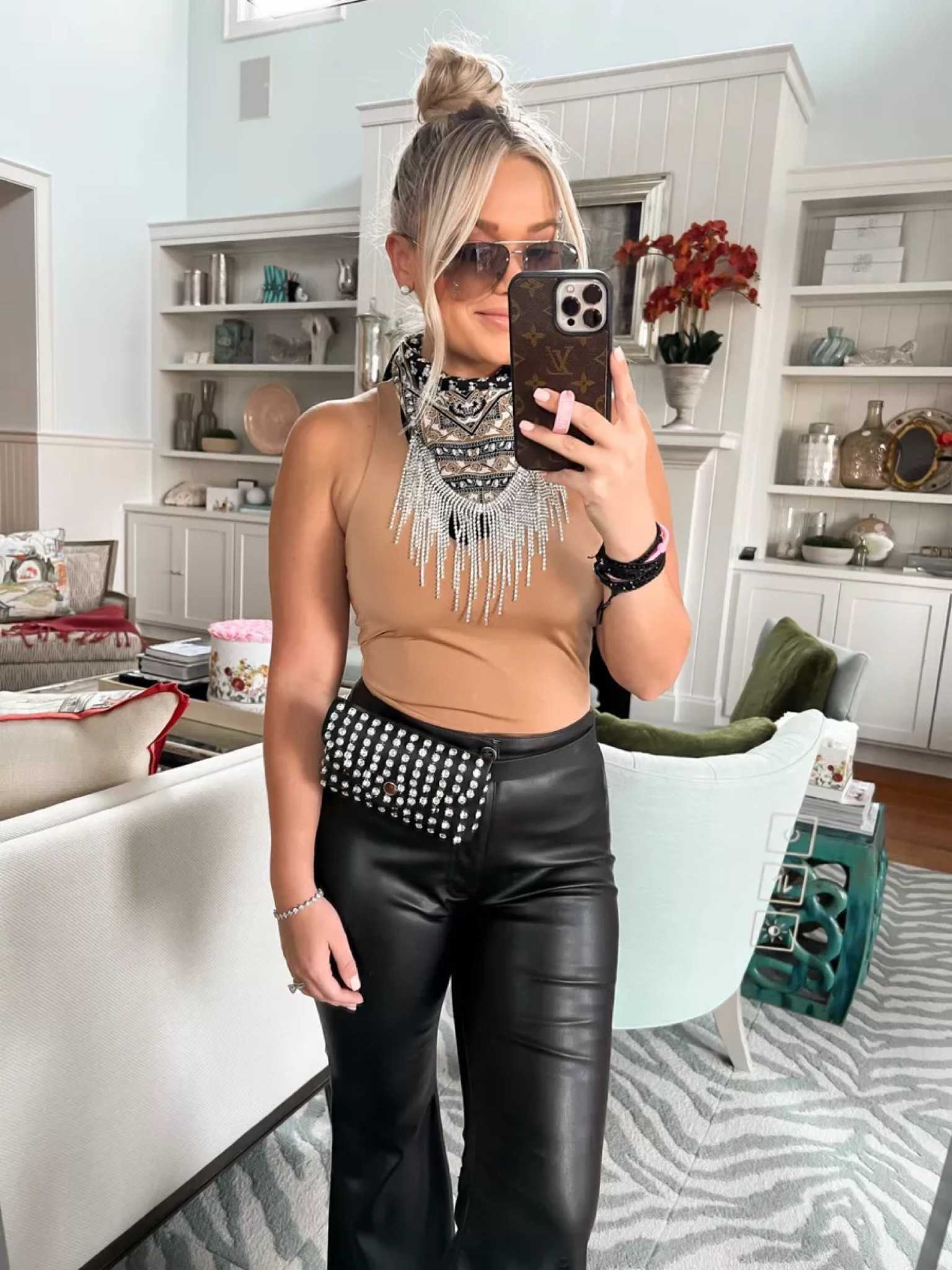 Bike Week Outfit. What I wear when riding the motorcycle. Motorcycle/bike week style. Edgy chic biker style. Harley Davidson style. Body contour flattering bodysuit. High neck bodysuit. Leather flare pants. Rhinestone fringe bandana. Black western boots.

#LTKtravel #LTKfit #LTKstyletip