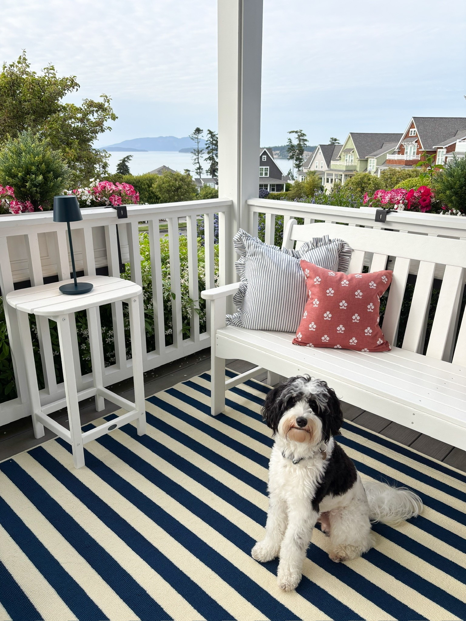 Coastal cottage front porch decor - outdoor bench, striped rug, pillows, cordless outdoor lamp, accent table, planter boxes

#LTKHome #LTKSeasonal #LTKSaleAlert