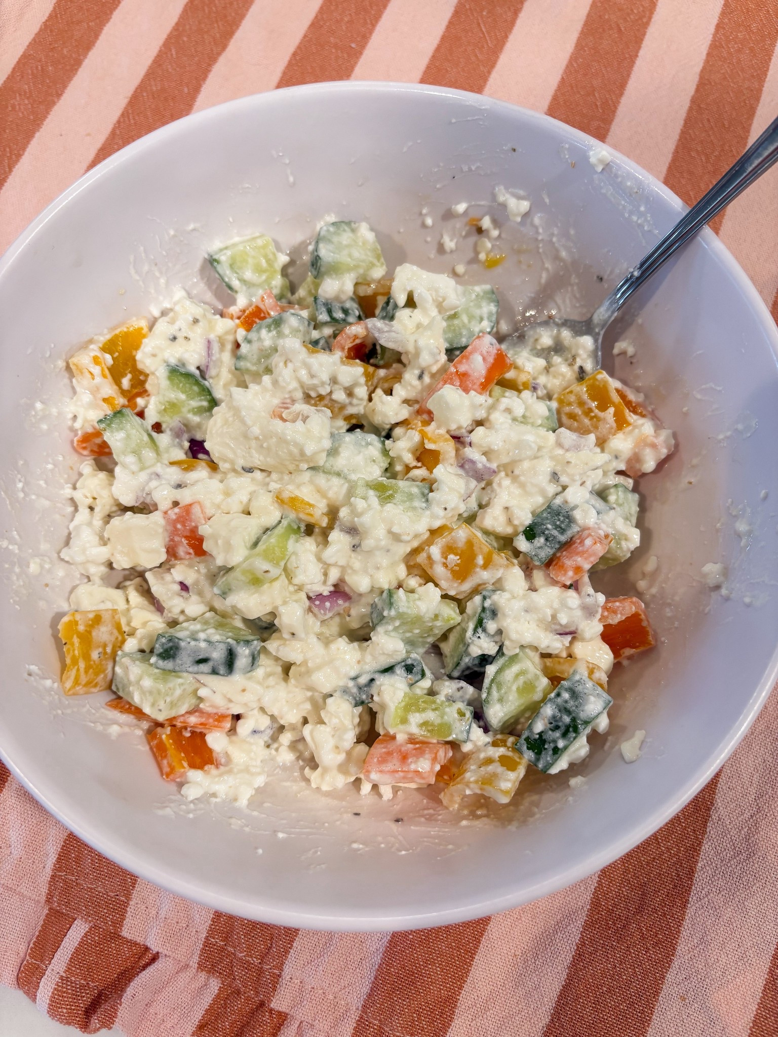 If you like pasta salad, and your looking for more ways to up your protein game — this is for you! 

Chop & put your cucumbers, sweet peppers, and red onion into a bowl. Add a good amount of feta cheese. Add about 3 big spoonfuls of whatever cottage cheese you prefer. Then top it off with Greek dressing. Mix and enjoy! 

For the record, I am not a fan of raw red onion. I did not add much to this mix, but the taste all blended together perfectly, so I feel they are necessary for this recipe!