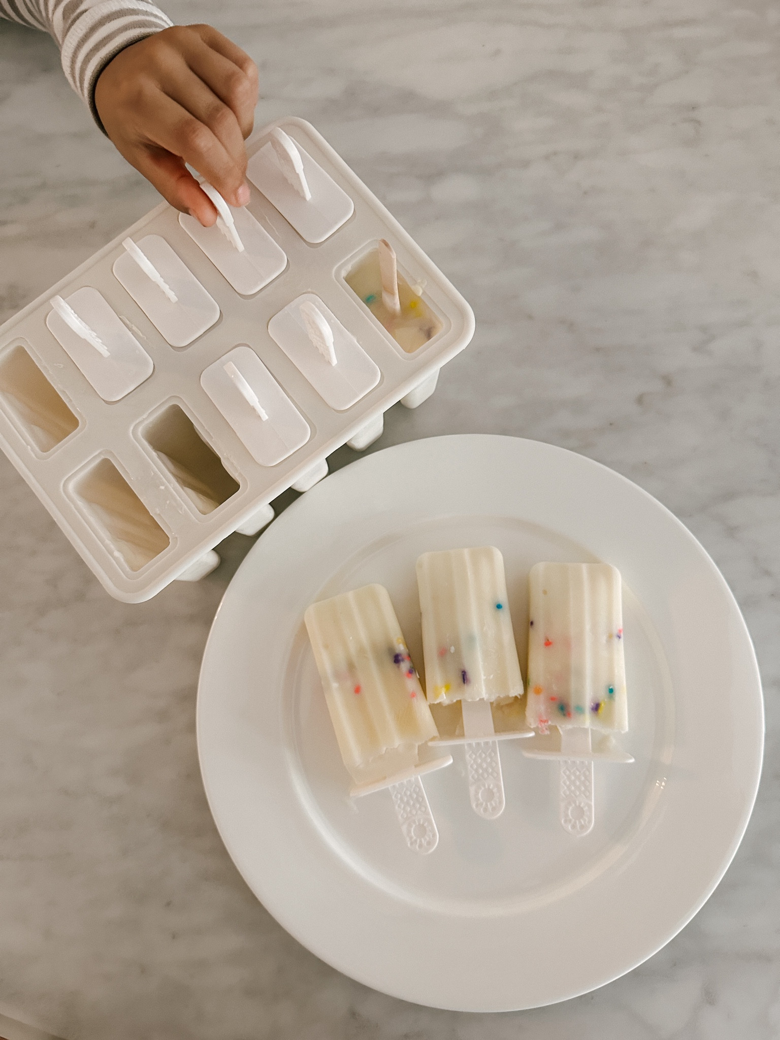 our fun easy summer activity today: made popsicles with yogurt + sprinkles + chocolate chip. kids loved it and thoroughly enjoyed it as a treat after lunch. linking our popsicle mold. comes with reusable and disposable sticks. used the wooden one for a friend who was taking it home 😊  

#LTKHome #LTKFamily