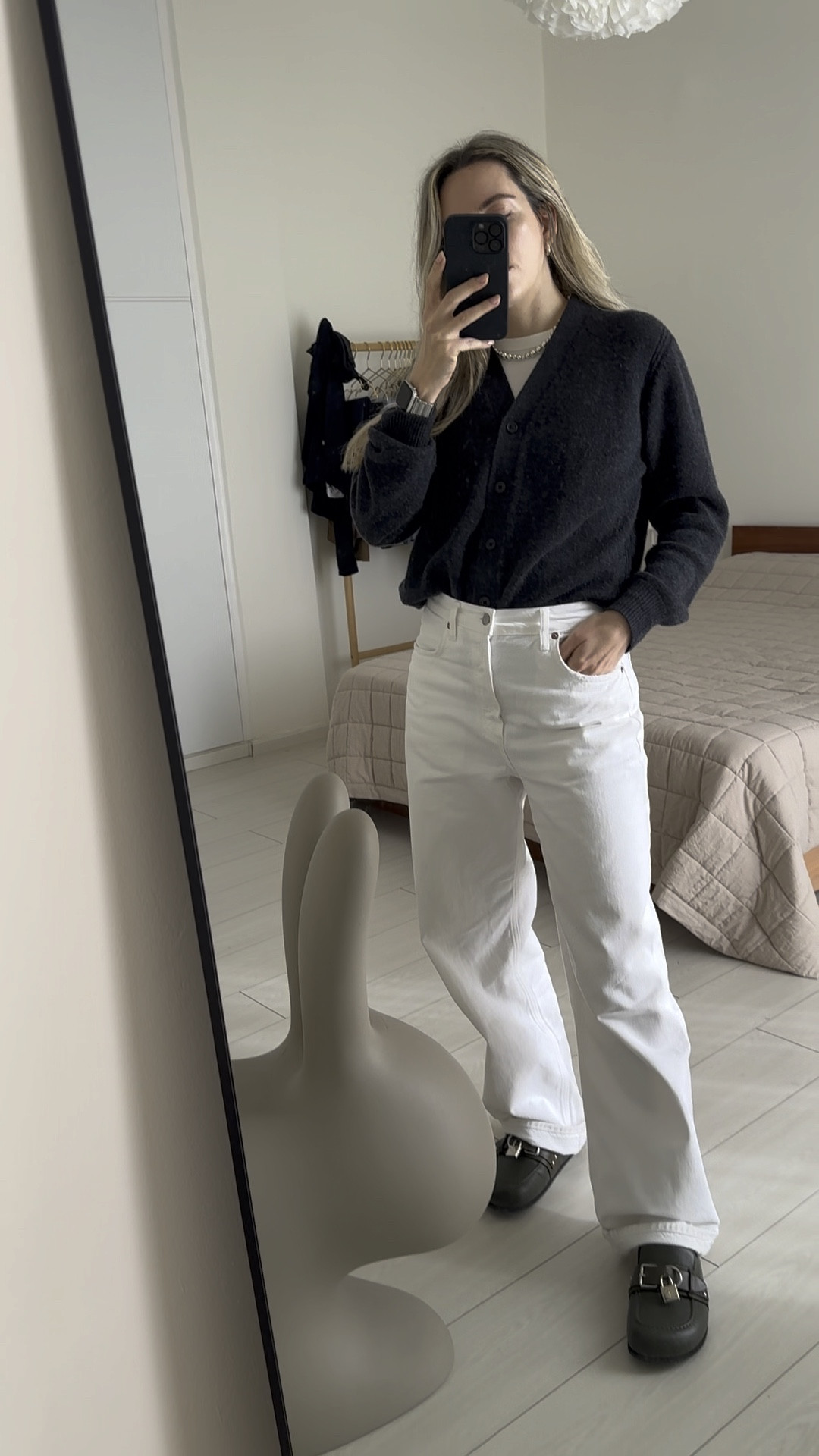 Perfect chill, cool & comfortable minimalistic outfit to go into 2024!

It’s an errands look if you pair it with slides like me or an amazing office look if you wear your classic black leather ankle boots.

-I love this Lié Studio necklace as it acts like a chic statement. I’ve linked the gold version as the Silver is still sold out.
-I’m wearing this Cos grey cashmere cardigan almost everyday! So cosy and true to size.
-These Agolde white wide-leg jeans are amazing but they run BIG in size. I sized down one size and I could size down even two. I’m wearing 26 in Agolde & went for 25 in these.
-Last but not least my fav JW Anderson slides that add that cool effect on any look. They also run big. Try a size smaller!

#LTKSeasonal #LTKstyletip #LTKworkwear