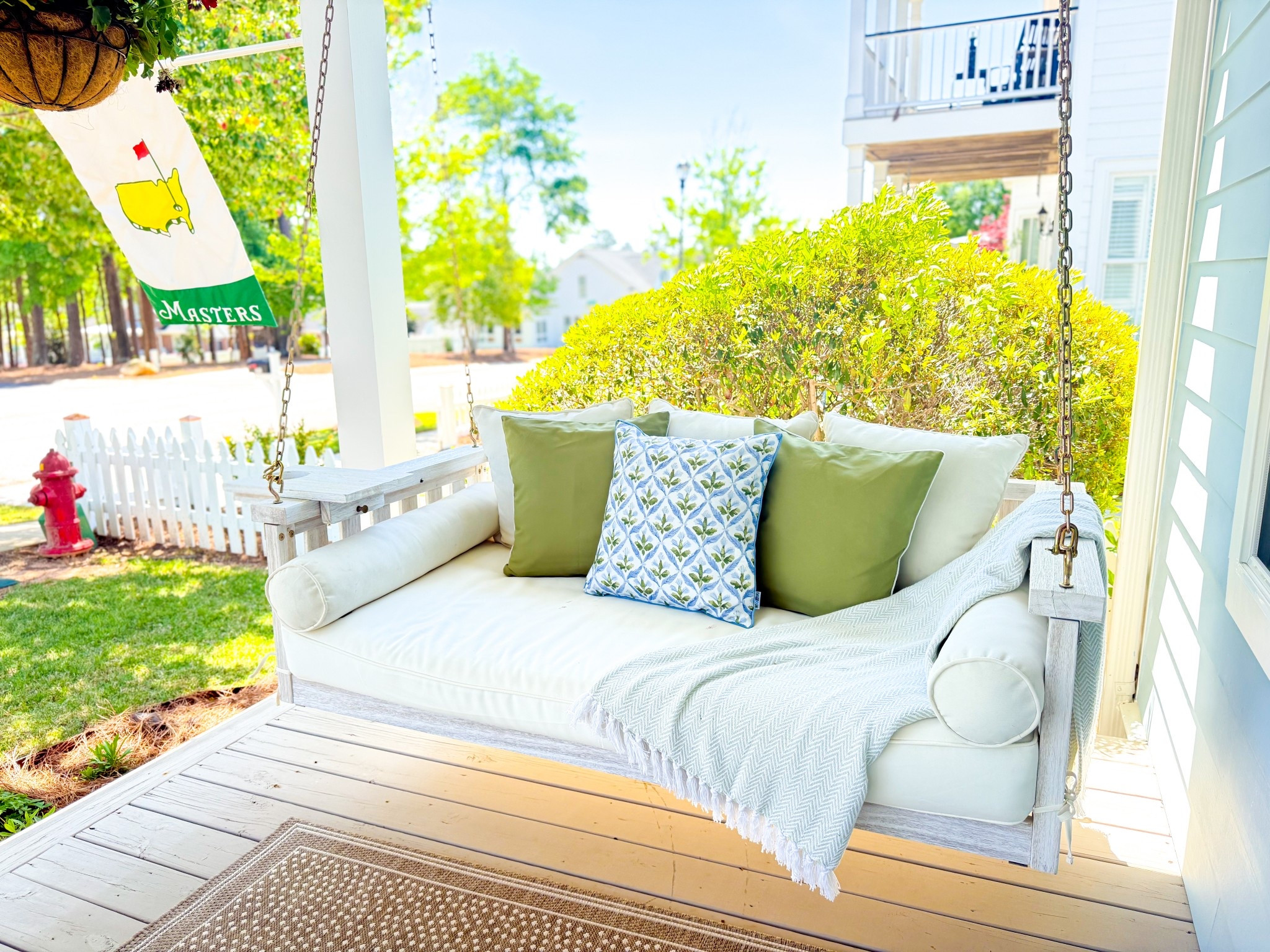 Front porch refresh.  This is where I have been spending my week in this cool spring weather.  🤍
#frontporch #swing #spring #blue #green #outdoorpillows 

#LTKHome #LTKFamily #LTKSeasonal