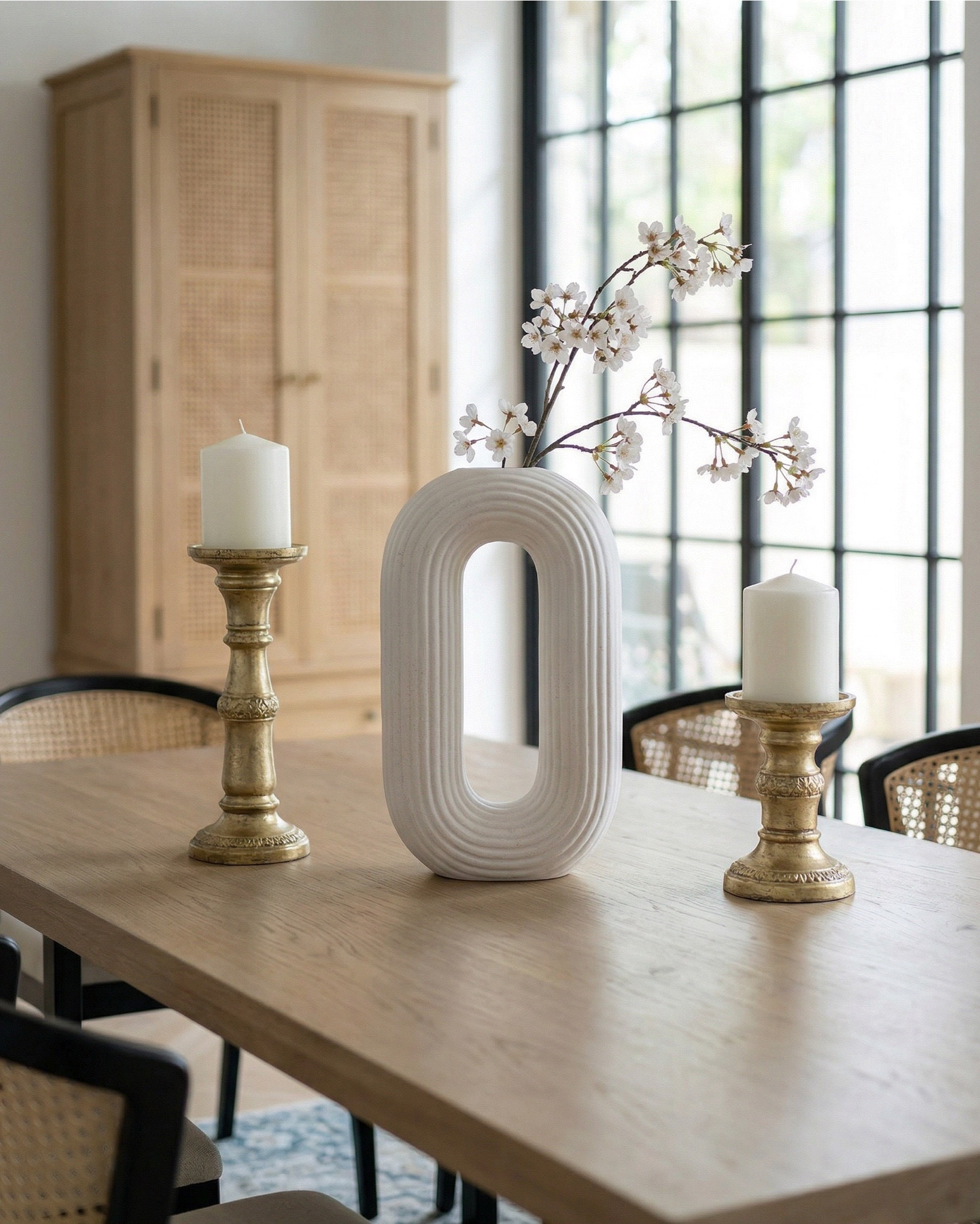 Shop the look: 
* Wood Dining Table
* Black upholstered dining  Chairs 
* Wood console table
* Brass table lamp 
* White ceramic vase
* Brass candle holders
* Blue wall art
* Neutral modern wall art
* Brass wall sconce 
* Wood cabinets 
* Blue traditional pattern rug
* Blue wall paper
* Tall ceramic vase
* Black decor bowl

#LTKhome #LTKsale #LTKstyletip