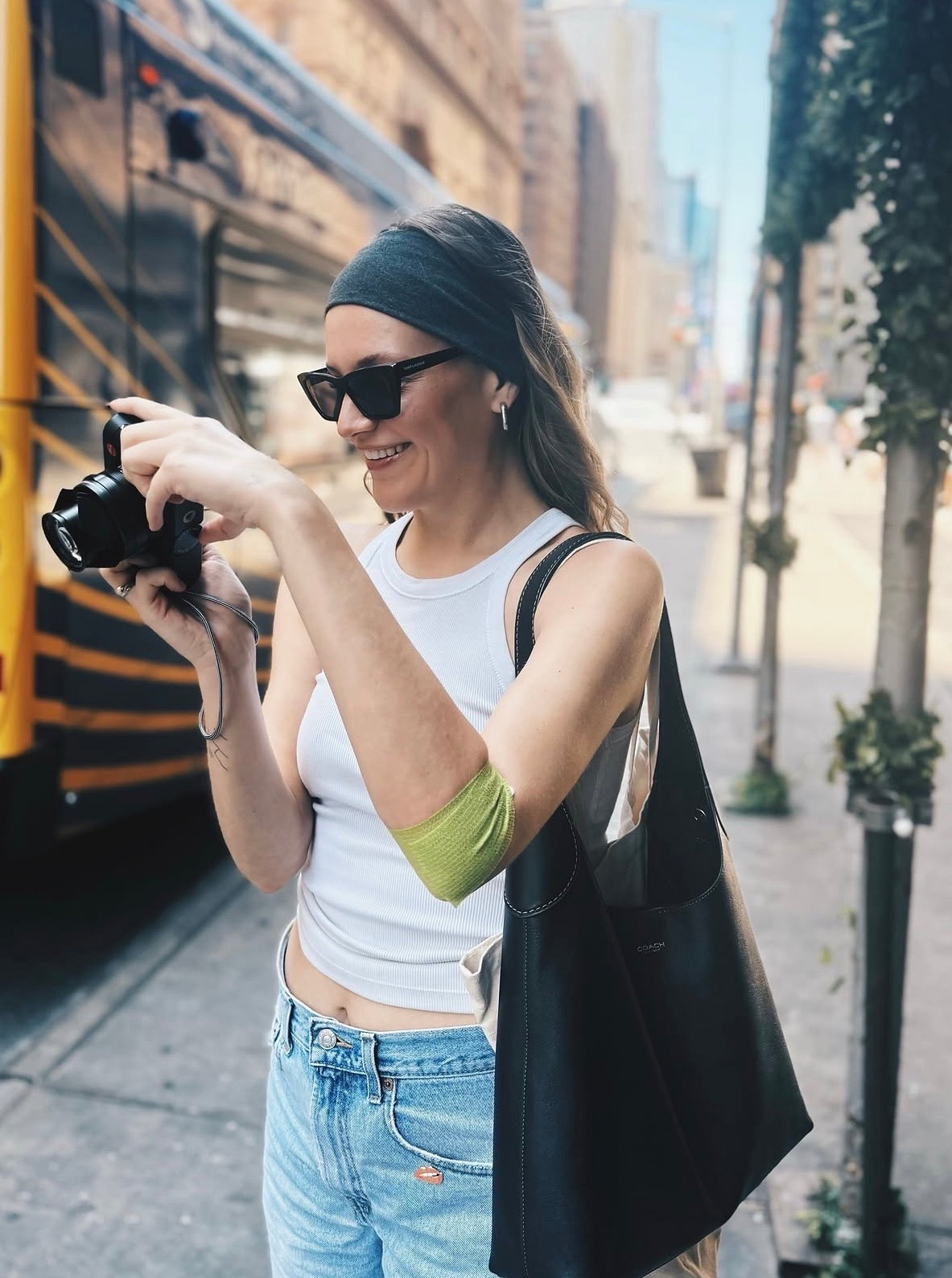 Kelsea Ballerini wearing a leather shoulder bag that is under $500 and black cat eye sunglasses ￼
