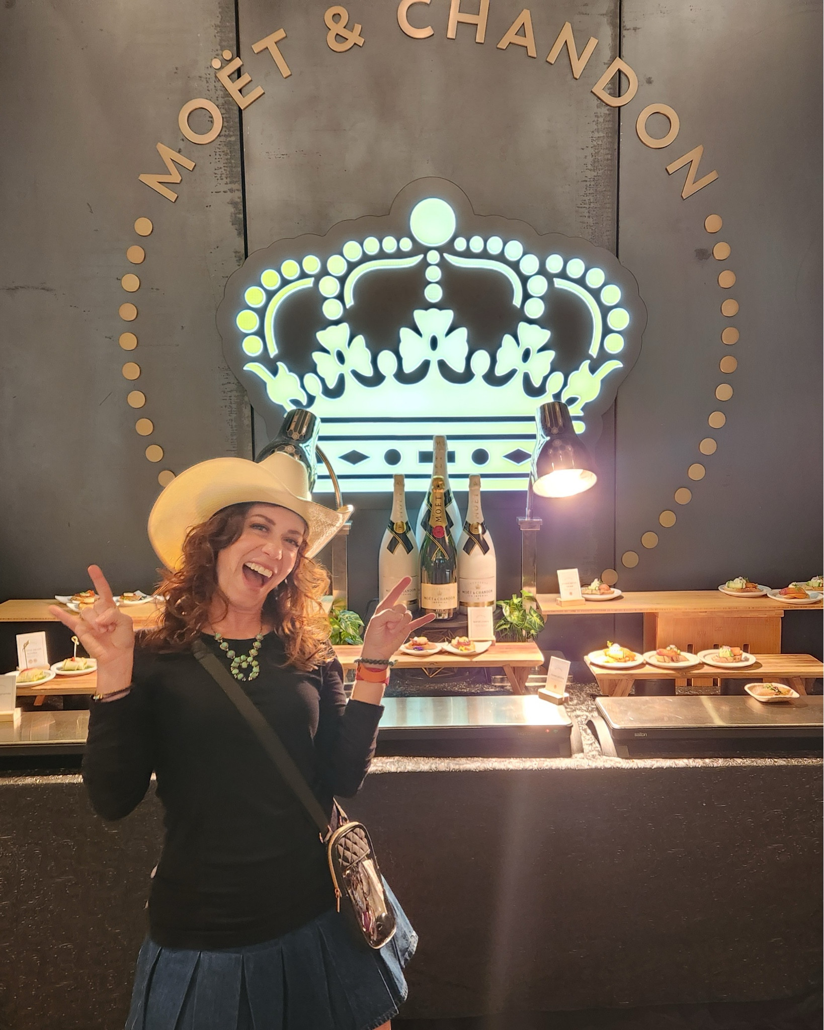 Kacey Musgraves in Austin: I ultimately decided on this comfy long sleeve crew neck, denim skirt, squash blossom necklace, cowboy hat and boots. Don’t forget your clear concert crossbody bag! All fun, no security hiccups. 👏