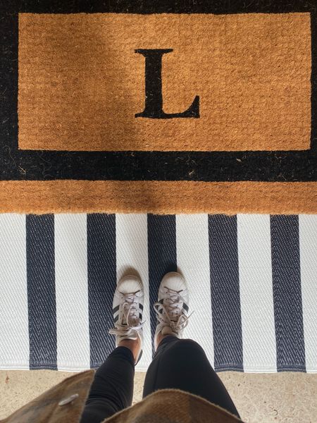 Front porch essentials. Layer you area rugs and doormat to make your entryway stand out. I used a monogrammed coir doormat and a striped outdoor area rug underneath. 
kimbentley, front porch, entry,

#LTKfindsunder50 #LTKhome #LTKSeasonal