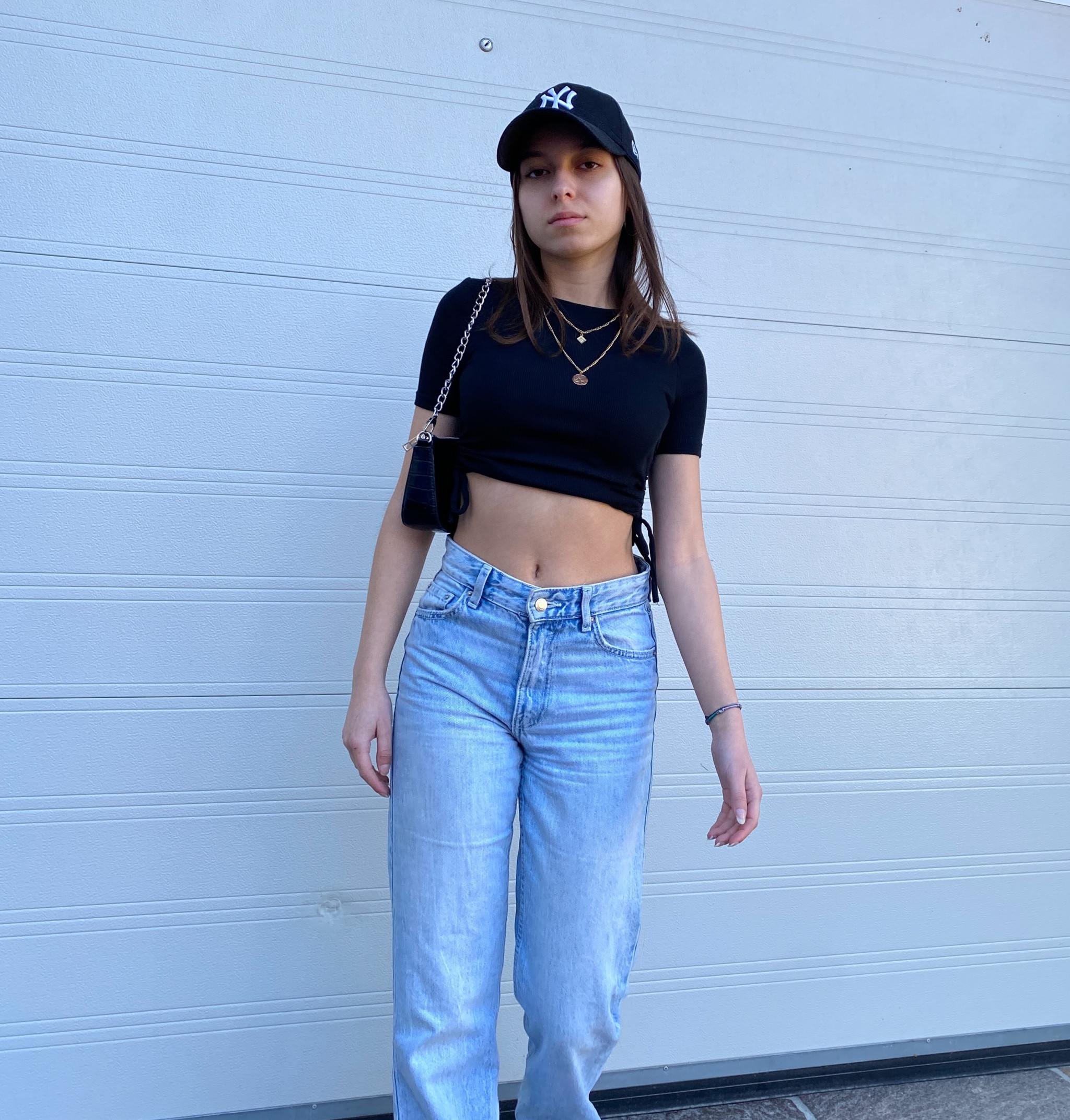 Black crop top, blue baggy jeans, black cap, black handbag, 

#LTKstyletip #LTKfit #LTKeurope