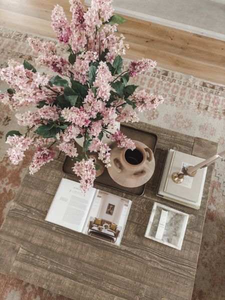 Spring transition coffee table decor! I have been loving the look of this square coffee table with neutral wood tones to tie into the rest of my spring living room 

Home finds, spring refresh, furniture favorites, coffee table decor, wooden furniture, faux florals, Pottery Barn style, vase finds, candle stick, gold tray, style inspo, area rug details, pops of pink, neutral wood tones, light and bright, living room refresh, found it on Amazon, shop the look!

#LTKhome #LTKSeasonal #LTKstyletip