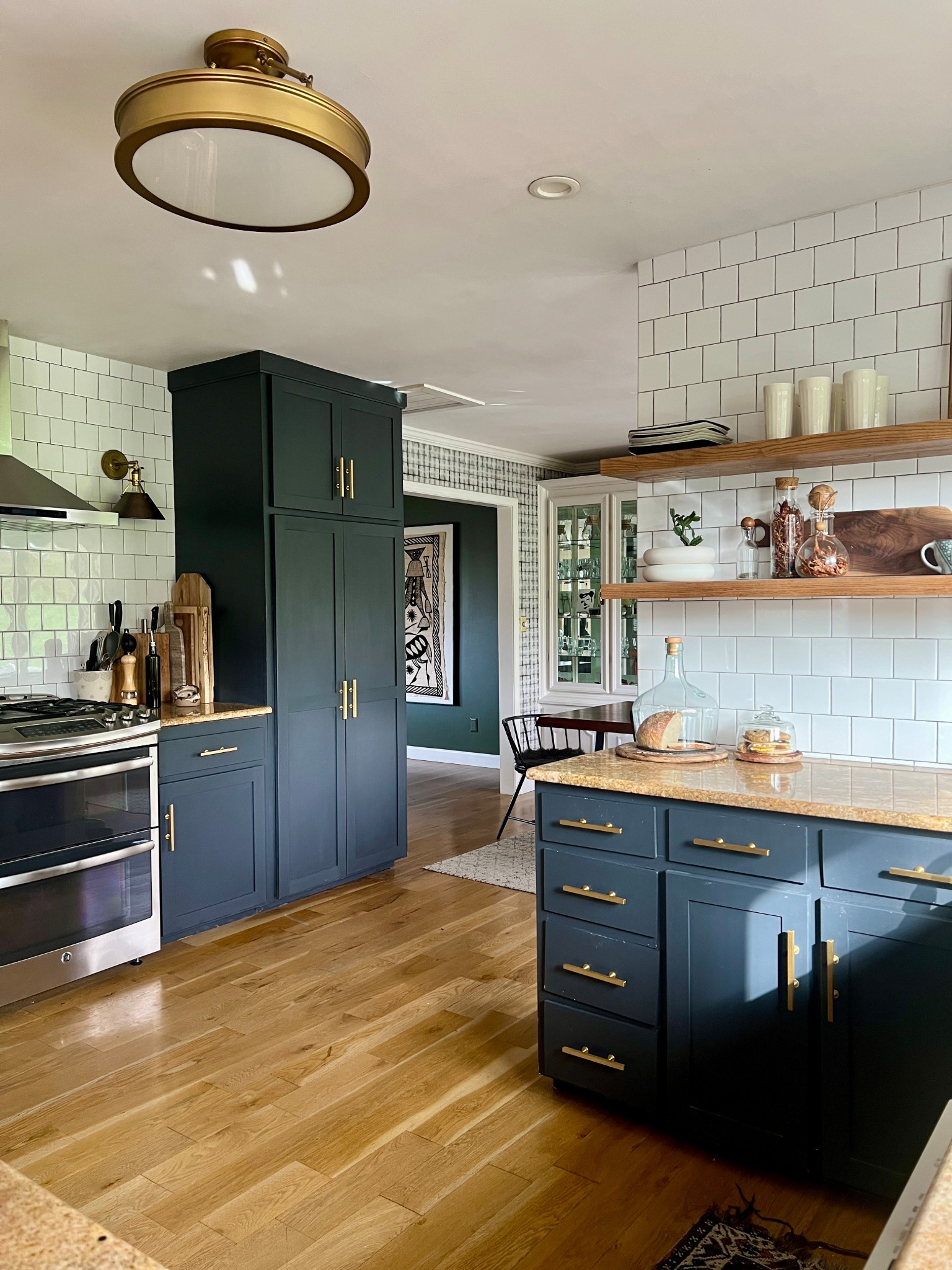 Sunny in the kitchen. Still love my bread cloche (mine is the medium size), bar pulls, and brass light! 

#LTKHome