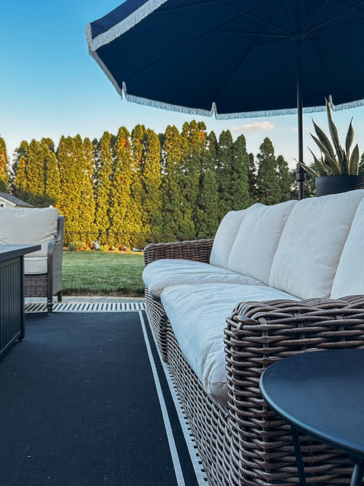 Outdoor patio sofa and love seat with black and white outdoor rug. This woven outdoor sofa is so comfortable and comes apart to become love seats!

#LTKSeasonal #LTKHome