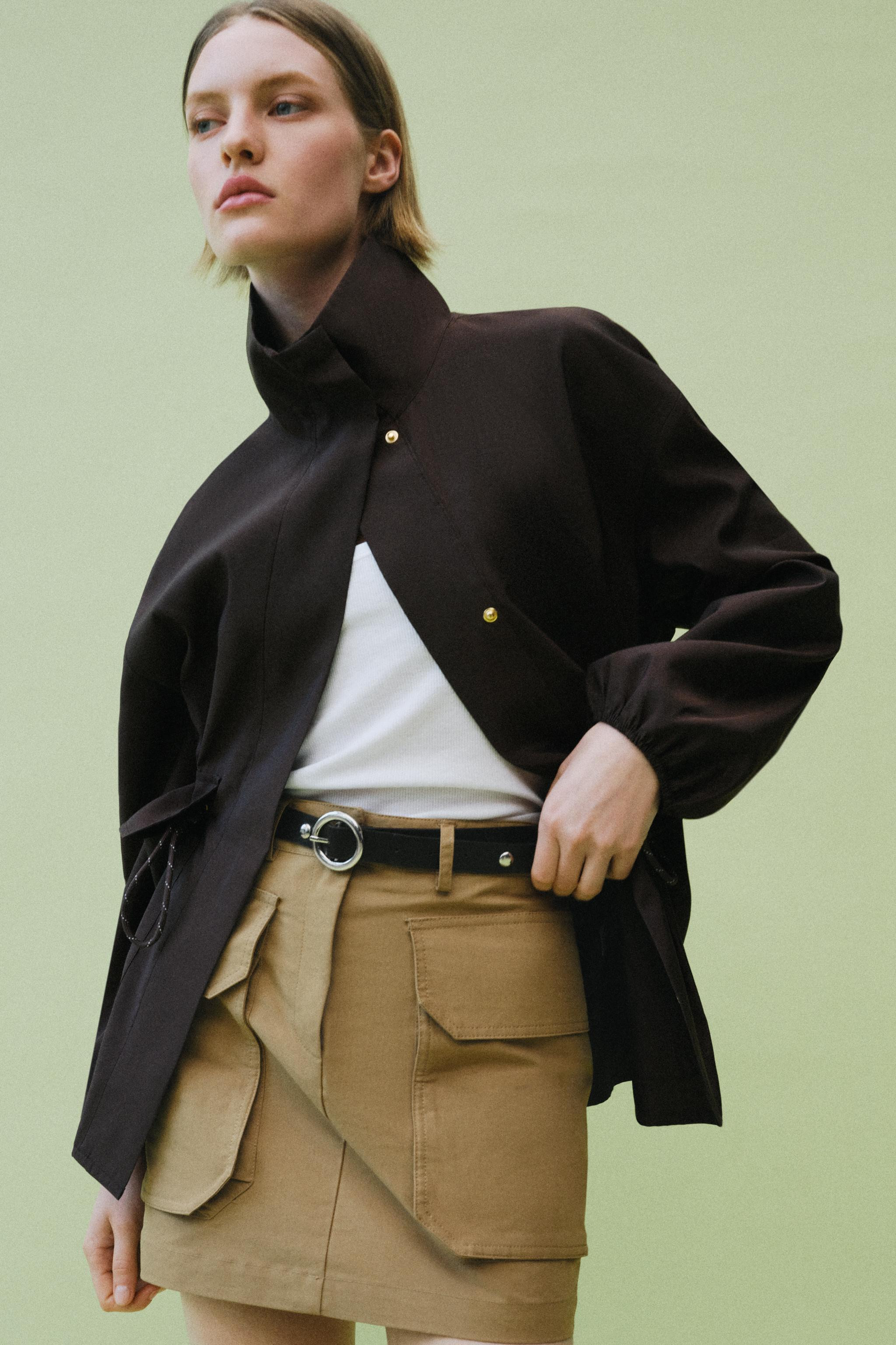 High collar jacket with long sleeves and elastic cuffs. Adjustable drawstring waist. Front patch ... | Zara US