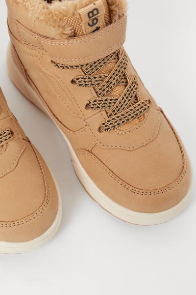 Waterproof high tops in faux leather. Padded edge and tongue, hook-loop tab at top, and elasticiz... | H&M (US + CA)