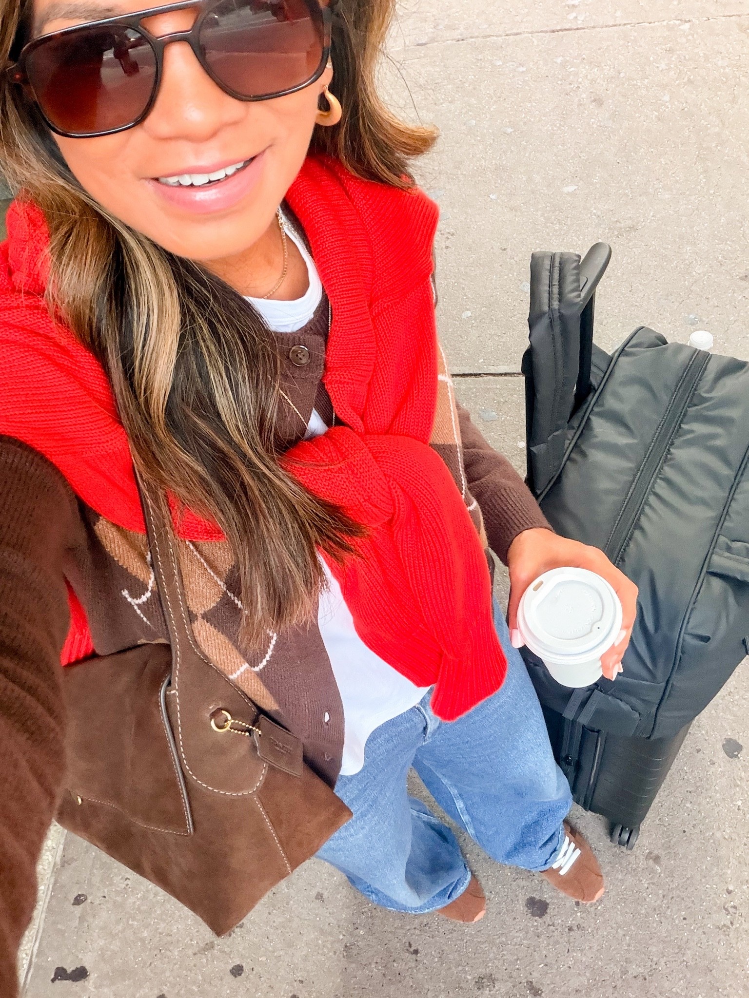 I’m 5’2” 118#ish for reference 
Airport Outfit!
I love my new fall bag so much! I used it in NYC, airport outfit, and as a clutch for date night last night!  The outside is real suede, inside is real leather, it’s lightweight! I have the color Dark Chocolate. The other colors is called Warm Brown and it’s so pretty too. Also comes in leather. I linked in a few stores.
Red sweater in small tts.
Argyle cardigan in small tts.
Sweatpant jeans I sized down to 25. Wash is Venice- still a favorite! There’s nothing like it! 
White tee in small tts. 
Sneakers fit tts-if you have wide feet reviews say to size up-I stayed with my true size. Very comfy! 
Carry-on luggage is the small size.
Personal bag(black) is linked-fits under most plane seats! 

airport outfit, travel outfit, fall outfit, fall bag, comfy sneakers, low profile sneakers, suede bag, Coach Chelsea 36, over 50 style, midlife fashion, petite fashion,midlife women, affordable fashion, fashion over40

#LTKNYFW #LTKPetite #LTKPetite #LTKNYFW #LTKTravel