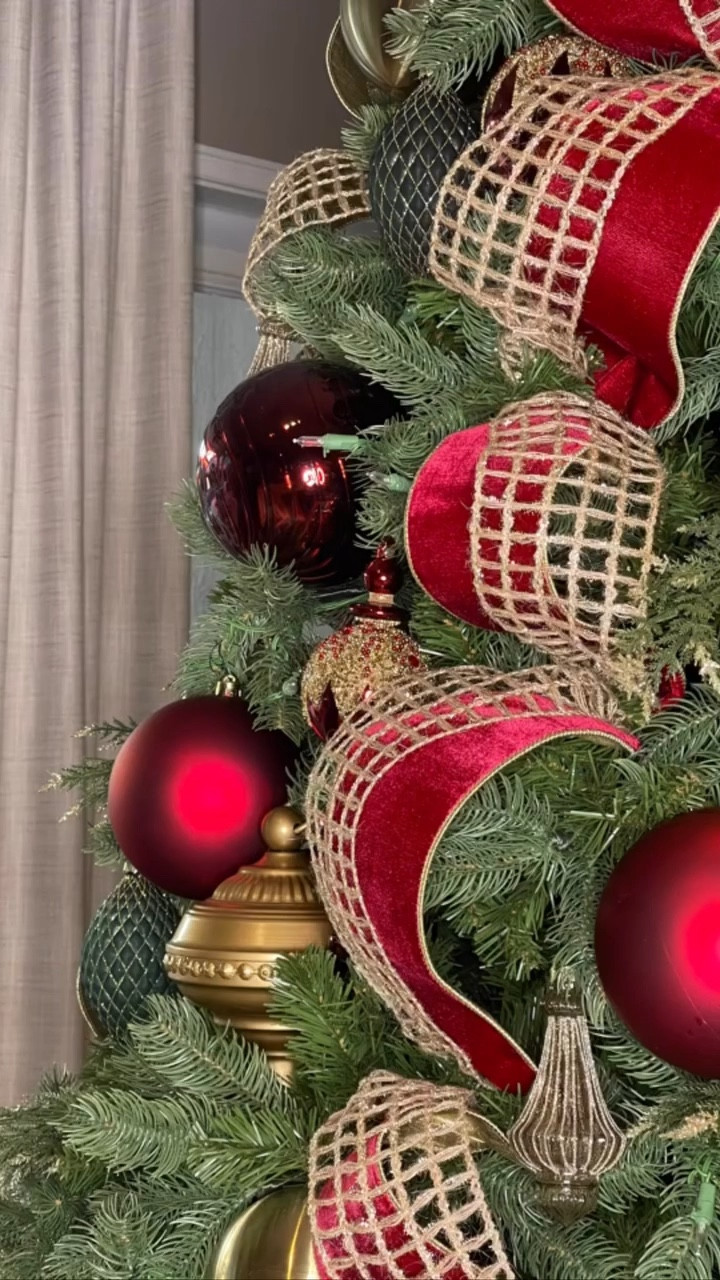 This is my living room tree this year.  This tree boasts a traditional Christmas vibe with an elegant flare. The ornaments are mostly glass, but there are a few that are metal or shatterproof. The carolers are stunning and I can’t find the same ones. I did tag some similar options here.
.
.
.
.
.
#christmasdecor #christmasdecoratingideas #christmastree #traditionalchristmas #traditionalchristmastree #christmascarolers #christmasribbon #elegantornaments #holdmyeggnog #burgundychristmas #christmastreestyling #traditional Christmas 

#LTKStyleTip #LTKSeasonal #LTKHome