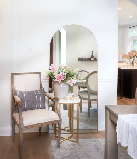 Spring refresh | Bringing the outdoors in with fresh blooms and reflecting more natural light in our dining room corner with an oversized leaning mirror. It is a tricky spot being the walkway to kitchen and directly in the entryway view but I think this is the winning configuration! And a plus that you can do a quick mirror check on your way in and out!

🌸Paint: SW Alabaster
🌸Flooring: The Masters Craft, Harroway
🌸Link in bio for product sources and more

#leaning mirror 
#gold floor mirror
#dining room decor
#spring refresh


#LTKSeasonal #LTKhome