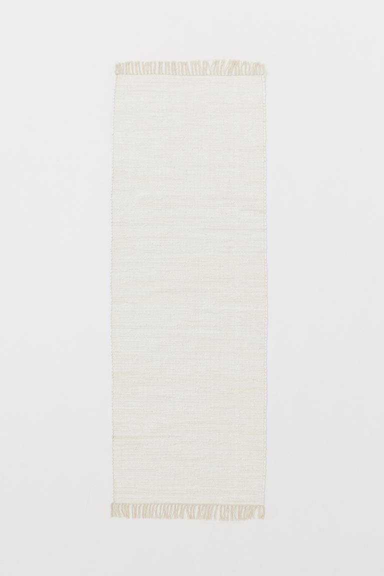 Oblong rag rug in woven recycled cotton. Fringe at short sides. | H&M (US)