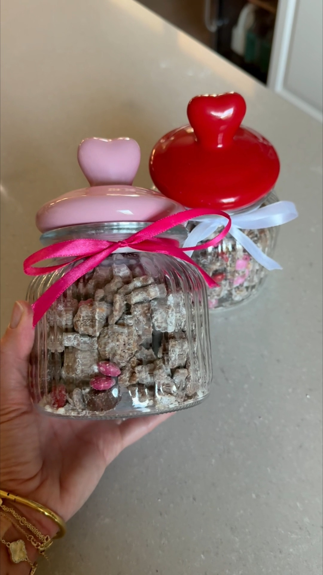 The reindeer food was such a hit, I put a little twist on it and we have cupid’s food 💘 Put it in a fancy little jar and makes a perfect gift 🎁 

Recipe
• 1 ½ cups semisweet or dark chocolate chips
• 1 ½ cups creamy peanut butter
• 5 cups Rice Chex Cereal
• 1 ½ cups mini pretzels broken into pieces
• 2 cups powdered sugar
• 1 ½ cups of pink & red M&Ms
• 1 cup mini heart shaped peanut butter cups

In a large bowl, combine rice Chex cereal and pretzel pieces.
Melt peanut butter and chocolate together, either on the stovetop or in the microwave.
Pour peanut butter chocolate mixture over cereal/pretzel mixture and stir to combine.
Chill in the refrigerator until the mixture just barely begins to set up (about 30 minutes).
Remove the mixture from the refrigerator.
In a separate, large bowl, put ½ cup powdered sugar on the bottom of the bowl. Add half of the chilled mixture, then add another ½ cup powdered sugar over the cereal and the remaining chocolate/cereal mixture.
Gently stir until the powdered sugar is evenly distributed, tossing to coat the cereal with powdered sugar.
Chill the mixture again in the refrigerator until it’s set (about another 30-60 minutes).
Add more powdered sugar, ¼ cup at a time until the cereal/pretzel mixture is coated.
Add M&Ms and peanut butter cups and stir to combine.
Transfer to a serving bowl and serve.

Amazon, Target, Valentines Day treat, Valentines Day gift, Valentines day party, reindeer food, Cupid’s food, seasonal treat, kids snack

#LTKfoodie #LTKmomlife #LTKSeasonal