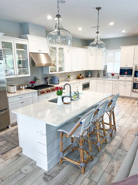 My kitchen favorites. Coastal kitchen. My kitchen rug. All clad stainless steel D5 pots and pans. Pottery barn pendant lights.kitchen must-haves. Pottery Barn plates. Serena and Lily riviera counter stools. 

#LTKfamily #LTKhome #LTKfindsunder100