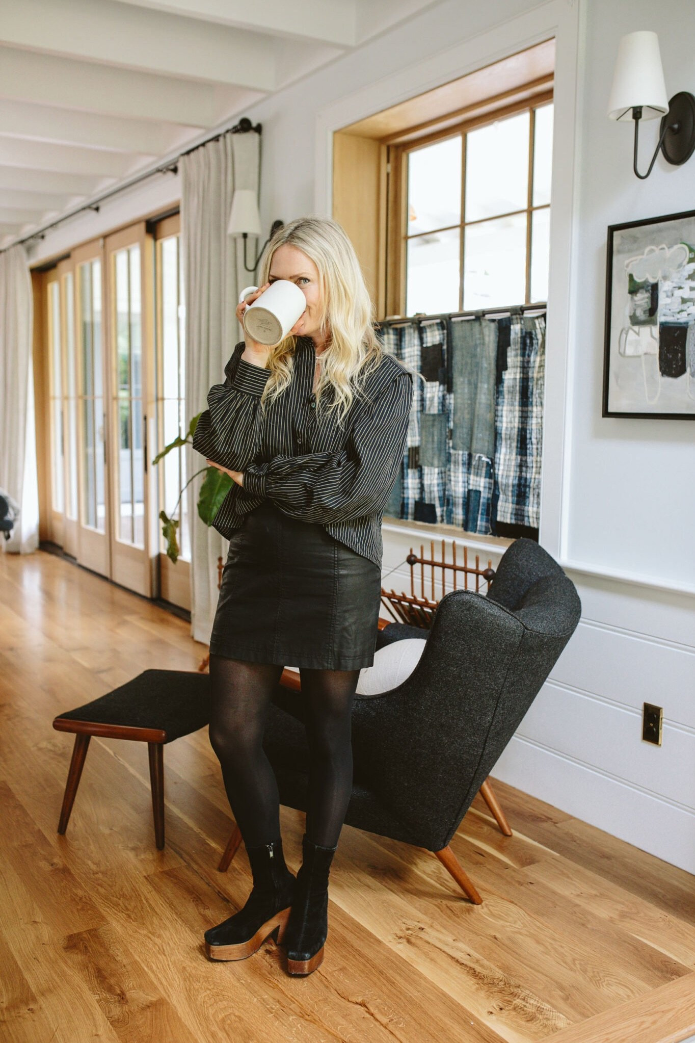 Another skirt I’ve had forever that I’m so glad I kept (same with the shoes, but these are so close). I wanted to calm down the vibe of the black leather with tights, wooden-heeled shoes, and again, a blousy top (I just bought this for a huge shoot I had a few weeks ago). I really look like I love drinking coffee in my mini skirt ha. But honestly, I do really love this look and feel good in it. #LTKCyberWeek 

#LTKstyletip #LTKGiftGuide #LTKover40