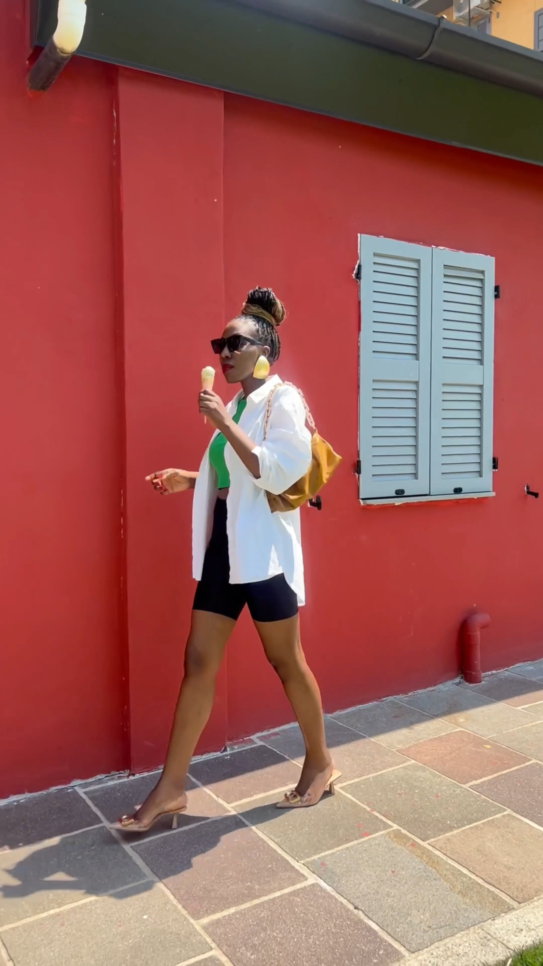 Styling biker shorts for Summer. Biker shorts, oversized white shirt, green crop top, sandals. 

#LTKSeasonal #LTKeurope #LTKstyletip