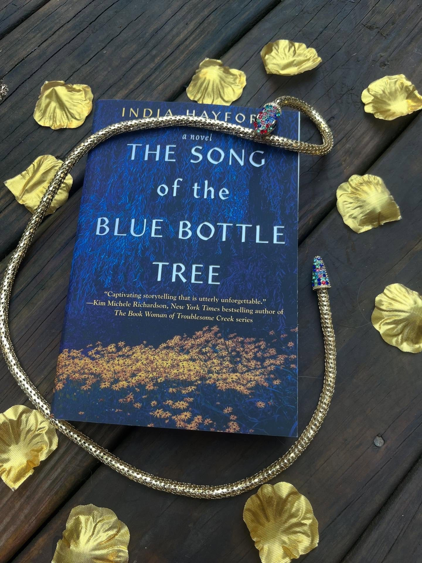 Book 26 of 2025 ⭐️⭐️⭐️⭐️

The Song of the Blue Bottle Tree
By: India Hayford 

Thanks to @tandemcollectiveglobal for allowing me to be a part of this readalong and introducing me to this amazing book! 

Genevieve returns to her childhood home in rural Arkansas in 1967 after years in exile and living under a new name. She can talk to ghosts — and maybe snakes — and carries the weight of a traumatic past filled with abuse. Her only fond memory is of her grandmother, and it’s that connection that brings her back.
As she reconnects with family and meets others in town, she’s faced with new and old trauma. Told from multiple perspectives, the story blends Southern folklore, ghostly encounters, and the harsh realities of life in a struggling community. The Songs of the Blue Bottle Tree is haunting, lyrical, and unforgettable — a story you won’t want to put down.

Growing up in the south, I love a good southern folklore. What about you? 

 #thesongofthebluebottletreereadalong @indiahayfordbooks @kensingtonbooks #bookish #alwaysreading #booksbooksbooks #readersofinstagram