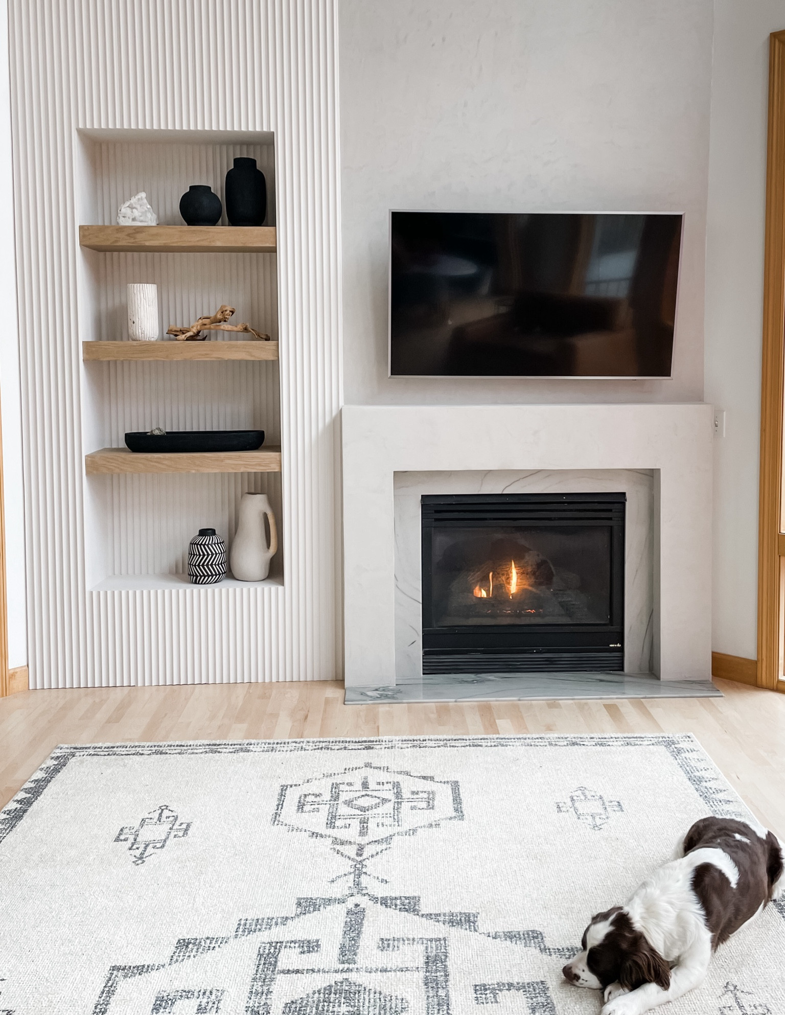 This fireplace makeover called for finishing touches as beautiful and textural as it turned out! 

Style tips:
▪️Neutral pieces with beautiful texture or interesting details (like rattan wrapped handles) elevate while still feeling calm.
▪️When styling shelves, scale up in size and leave some room to breathe.  I always prefer fewer, larger pieces that give impact over visual clutter.
▪️Create harmony by carrying a palette consistently throughout a display. Here, we balanced our use of black and white/ivory between the shelves so it doesn’t feel heavy.
▪️Compositionally, play with different groupings of 1-3 on each shelf, and make sure not to repeat from shelf to shelf.
▪️Rugs can add the perfect amount of pattern to finish a neutral space. 
▪️Bonus: easy care rugs are looking and feeling better, and easier to find! 🙌🏼

#LTKfamily #LTKhome #LTKstyletip