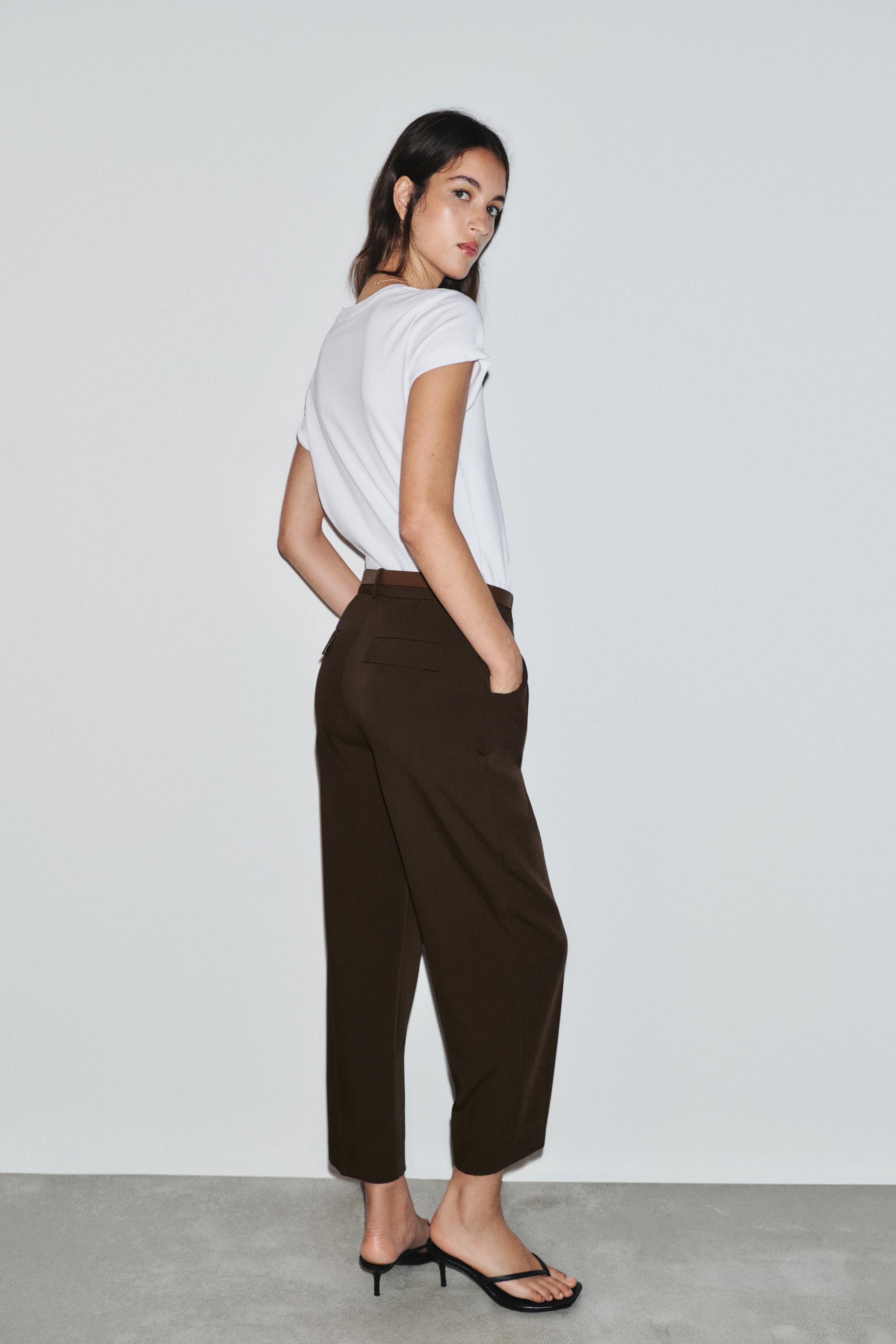 Mid-rise ankle pants with belt and front darts. Front pockets and back faux flap pockets. Front z... | Zara US