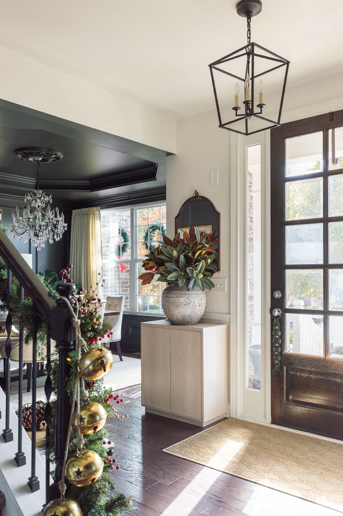 The entry blends the dining room, conversation room and big living room together, so I typically stay simple and universal in here. My faux magnolia branches are a staple throughout the year and sometimes I switch out the large vase. home decor Christmas decor foyer decor accent cabinet cement vase bronze mirror lantern chandelier

#LTKSeasonal #LTKHome #LTKHoliday
