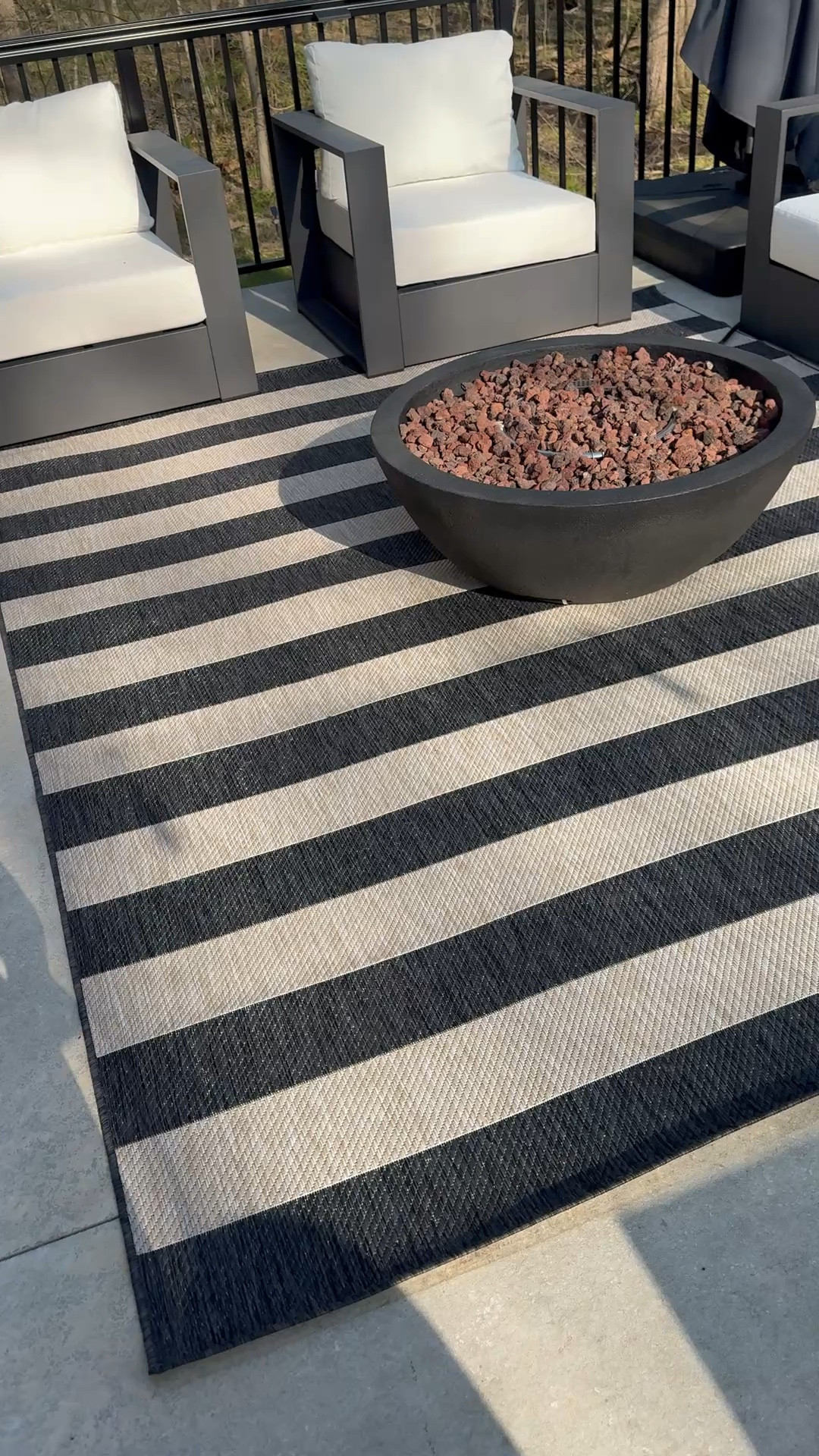 Setting up my upstairs patio. I added this black and beige striped outdoor rug that dries quickly. 