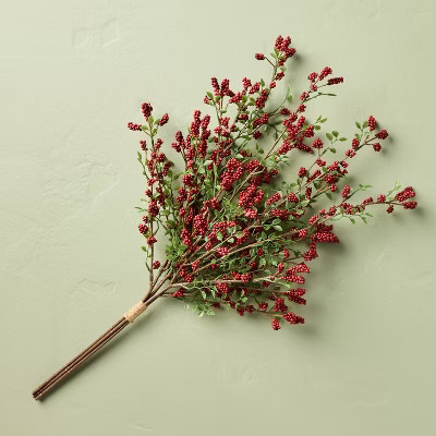 A bundle of faux cedar stems with red berries