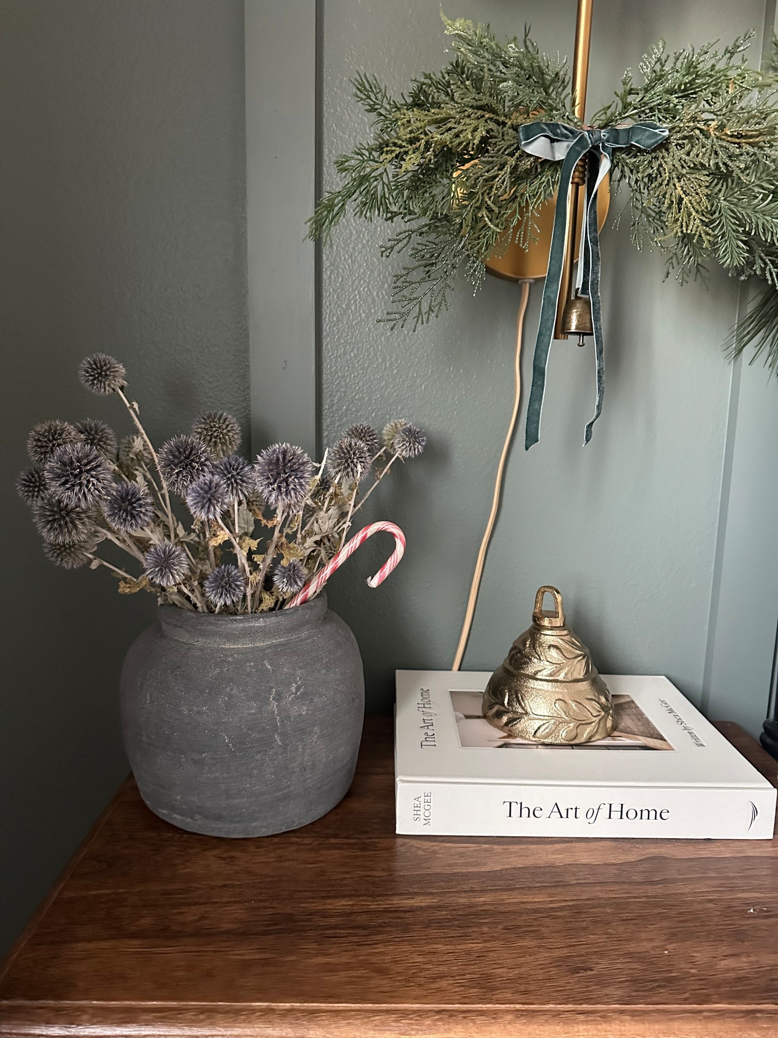 Guest bedroom Christmas decor! When I don’t want to change out my florals for Christmas I always just throw a candy cane into the vase! 

Candy cane, brass bell, Christmas swag with bow 

#LTKHoliday #LTKSeasonal #LTKHome