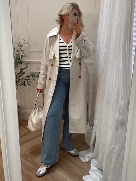 Trench coat outfit with blue wide leg Abercrombie jeans and adidas sambas 

Cream Trench 
size M

90’s high waist Wide leg jeans 
W28 - reg length 

Stripe cardigan vest 
Size M 