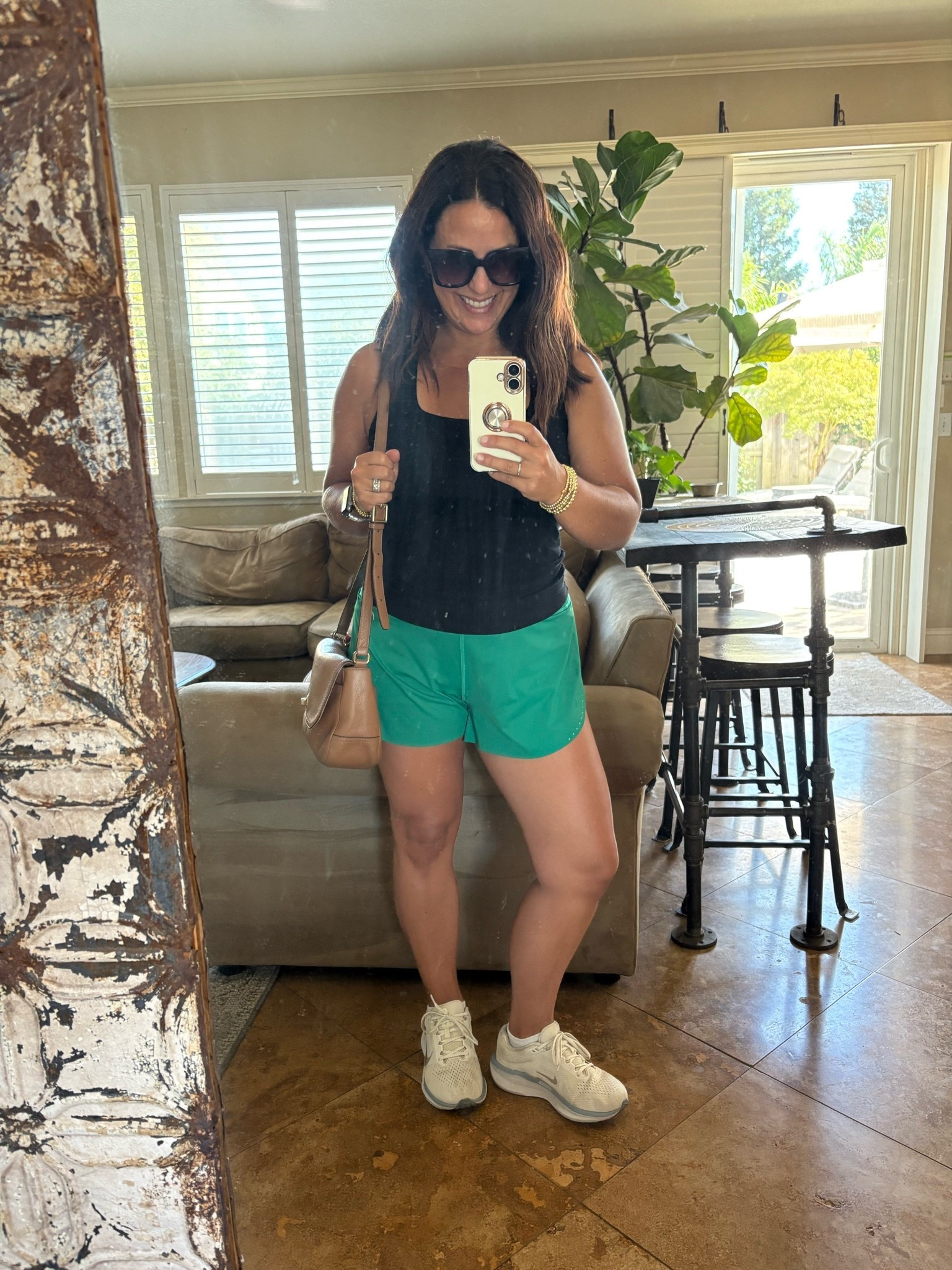 Just finished my workout and headed out to run errands! 💚 Loving this comfy athleisure outfit with athletic shorts, a black tank with built in bra, and white sneakers. The perfect casual summer outfit for busy days.

#LTKmomlife #LTKfitnessgoals #LTKootd