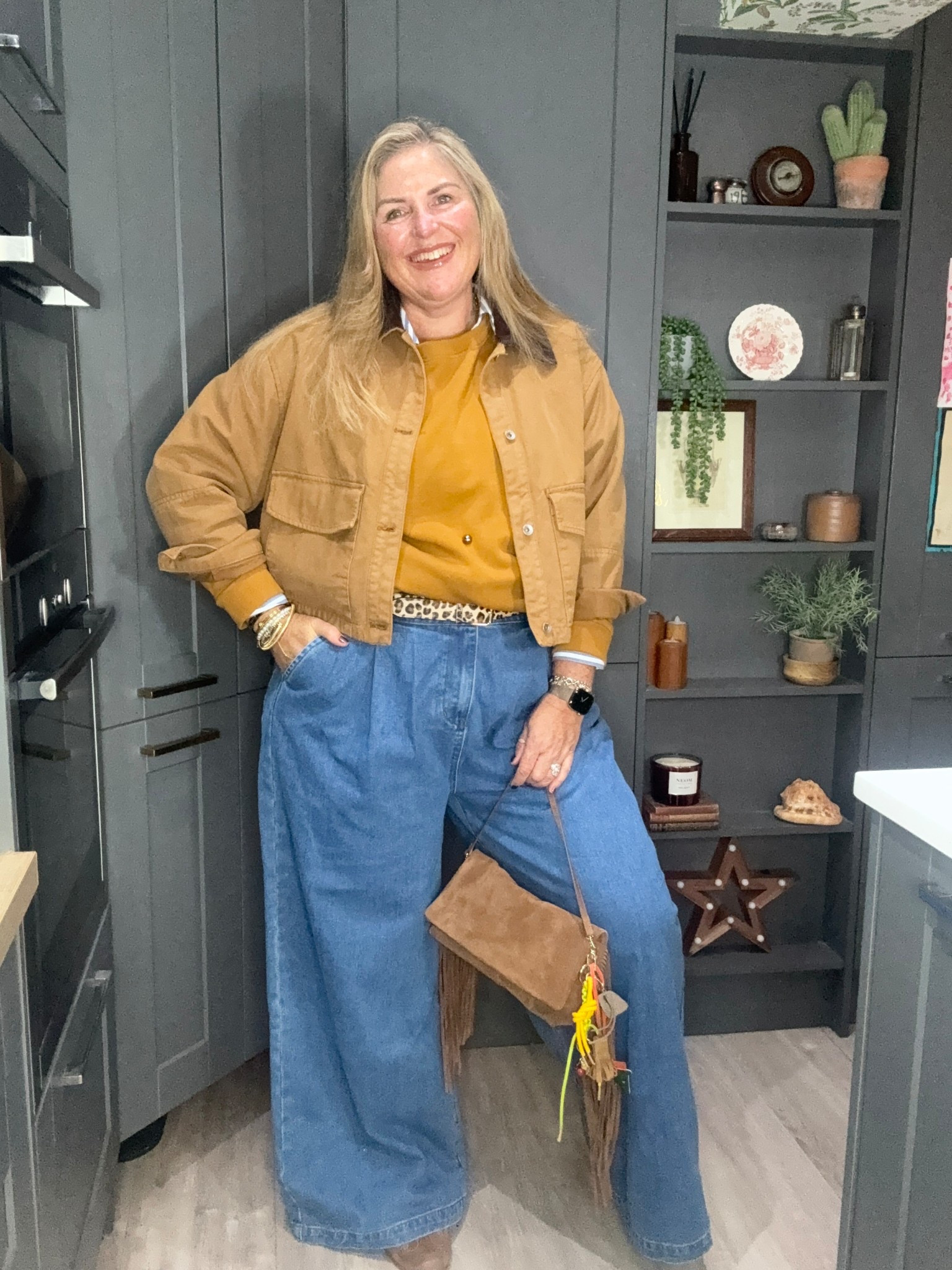 Tan barn jacket, tan studded sweatshirt, wide leg jeans, tan suede trainers, suede tassel bag, striped shirt 

#LTKjeans #LTKautumn #LTKplussize