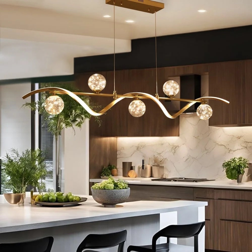 The 6-Light LED Linear Kitchen Island Light in Gold brings a polished, modern touch to the kitchen with its warm gold finish, glass globe shades, and dimmable LED lighting. A beautiful statement piece above a kitchen island, dining table, or bar area. ON SALE and under $200.

Ideas:

* kitchen island lighting
* gold light fixture
* modern kitchen décor
* glass globe lighting
* elegant home lighting

Keywords:

* kitchen island lighting
* gold pendant light
* linear pendant light
* kitchen island chandelier
* gold chandelier
* glass globe pendant
* LED kitchen lighting
* dimmable light fixture
* dining room lighting
* kitchen lighting
* modern lighting
* gold light fixture
* kitchen décor
* modern home décor
* statement lighting

#LTKHome #LTKSeasonal #LTKSaleAlert