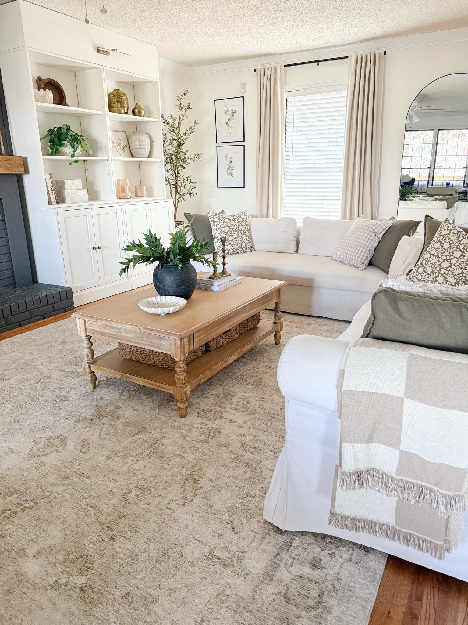 Simple, Neutral and cozy living room 

Pattern mix 
Neutral home 
Olive green 
Taupe 
Solid pillows
Floral pillows 
Gingham pillows
Vintage feel rug 
Shelf styling 

#LTKHome #LTKSeasonal #LTKStyleTip