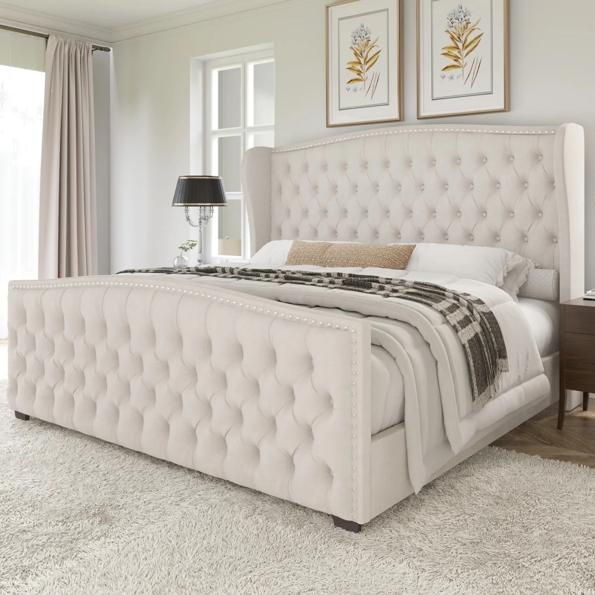 This cream upholstered queen bed from Wayfair has that cozy, pulled-together bedroom look without feeling too formal. The deep button tufting, wingback headboard, nailhead trim, and matching tufted footboard make it feel extra plush. Styled with crisp white bedding, a plaid throw, dark wood nightstand, black table lamp, botanical wall art, and a soft neutral rug, it’s such a pretty setup for a primary or guest bedroom. It’s included in Wayfair’s Labor Day Deal and currently only at $339.99.