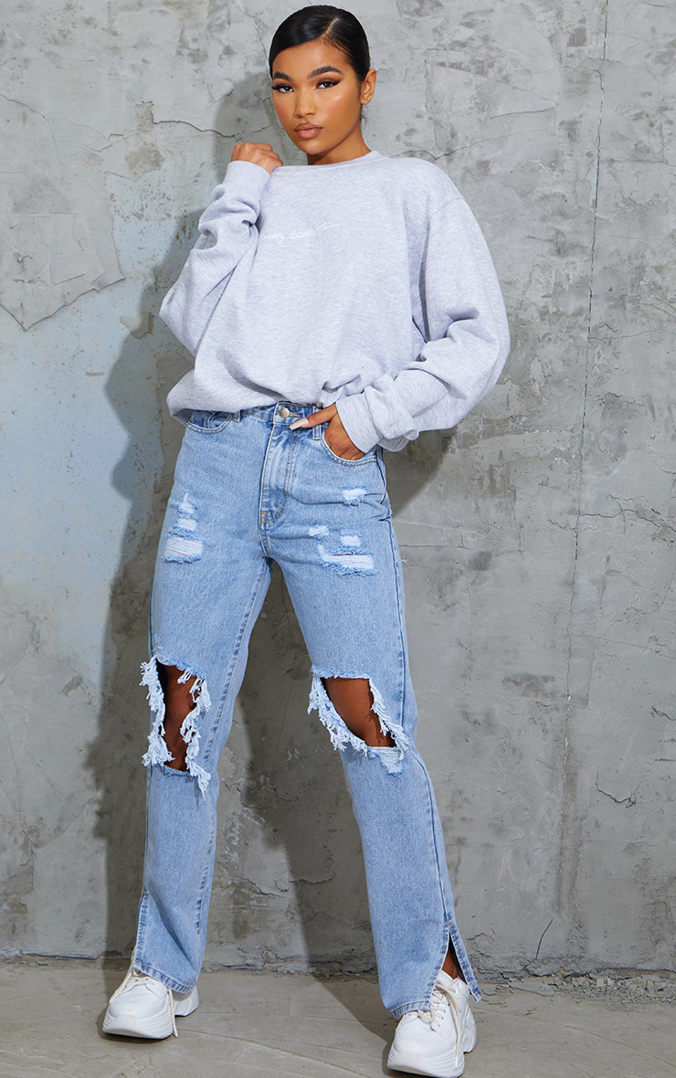Light Blue Wash Ripped Open Knee Split Hem Jeans | PrettyLittleThing US