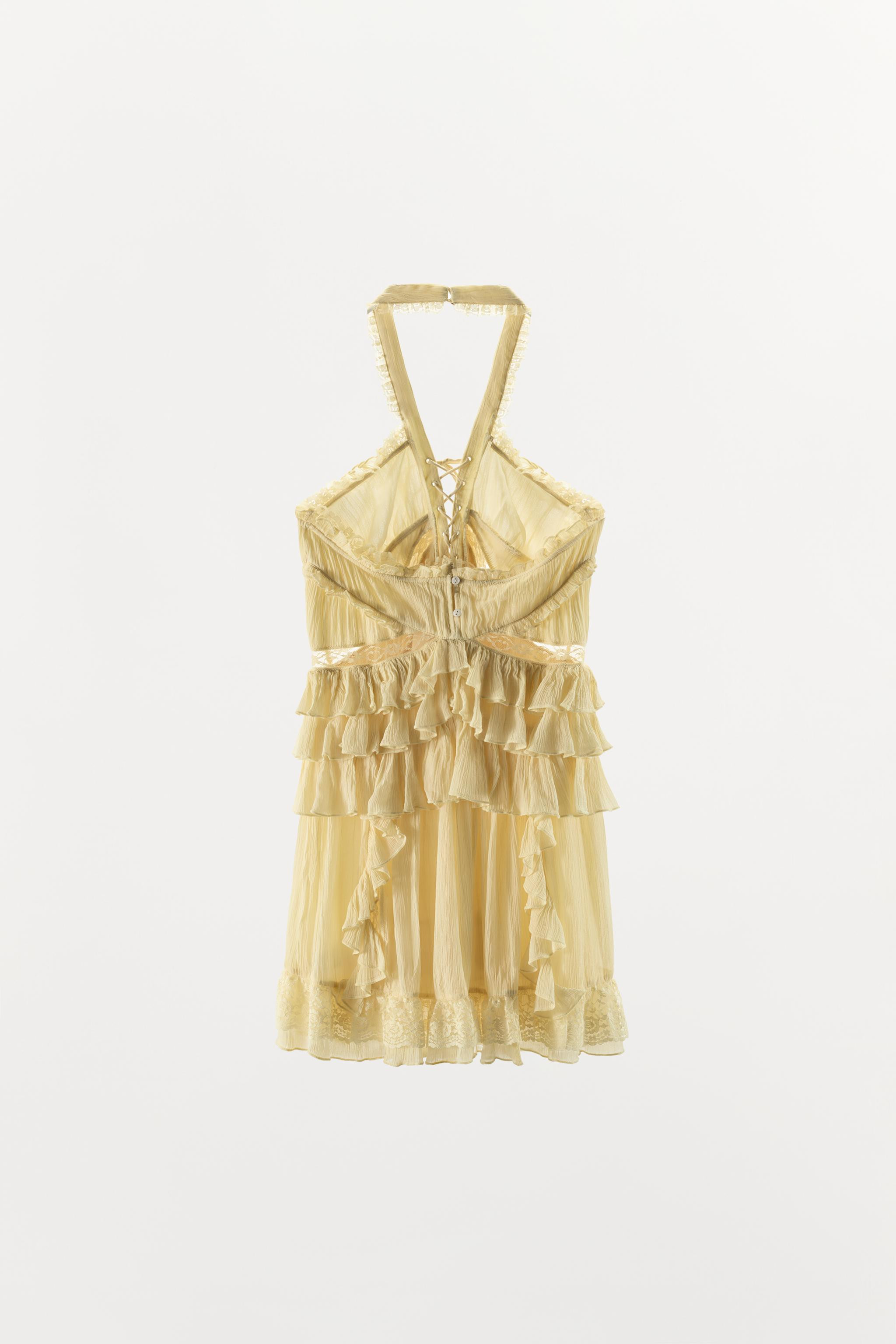 Short dress made from 100% viscose. Featuring a halter neck and a V-neck with adjustable tie deta... | Zara UK