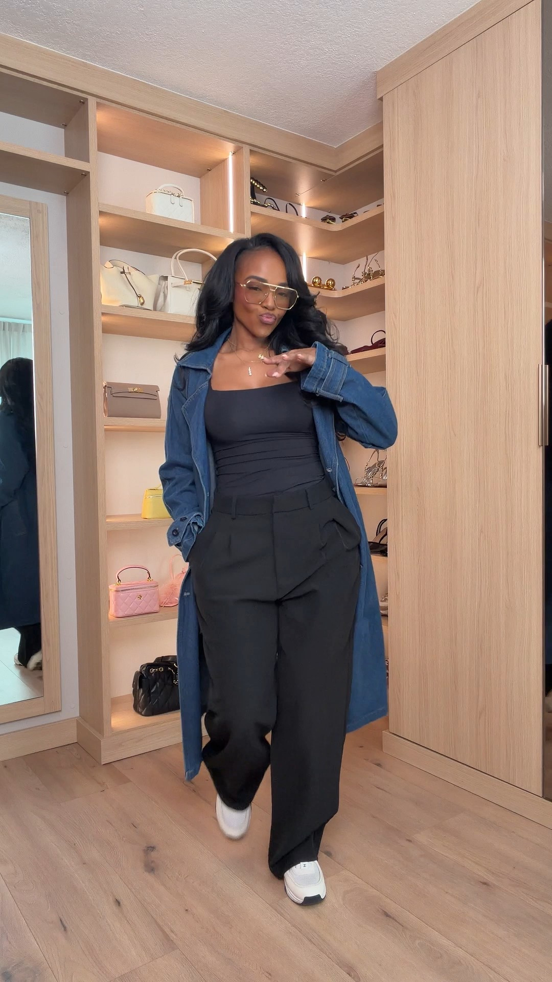 Effortless cool with a tailored twist 🖤  

Wide-leg trousers, a fitted black base, and a long denim layer — this is how you make comfort look intentional. The structured pants elevate the look, the denim adds dimension, and sneakers keep it wearable. Styled multiple ways (swap heels, add a blazer, remove the coat), and the cost per wear keeps getting better.

Relaxed. Polished. Repeat.

Perfect for:
• Travel days  
• Casual meetings  
• Weekend errands  
• Elevated everyday looks  

📏 Sizing:  
Top: Size Small  
Trousers: 27 Long  
Denim layer: Size Small  
Sneakers: True to size  

📐 Measurements:  
5’4” · 138 lbs · 34D bust · 27” waist · 40” hips  

Tap to get details and save this for your next chic off-duty moment.

Wide leg trousers outfit, black tailored pants women, denim duster styling, elevated casual look, chic airport outfit, minimalist street style.

Follow me on Instagram and YouTube @kirasfashionfinds