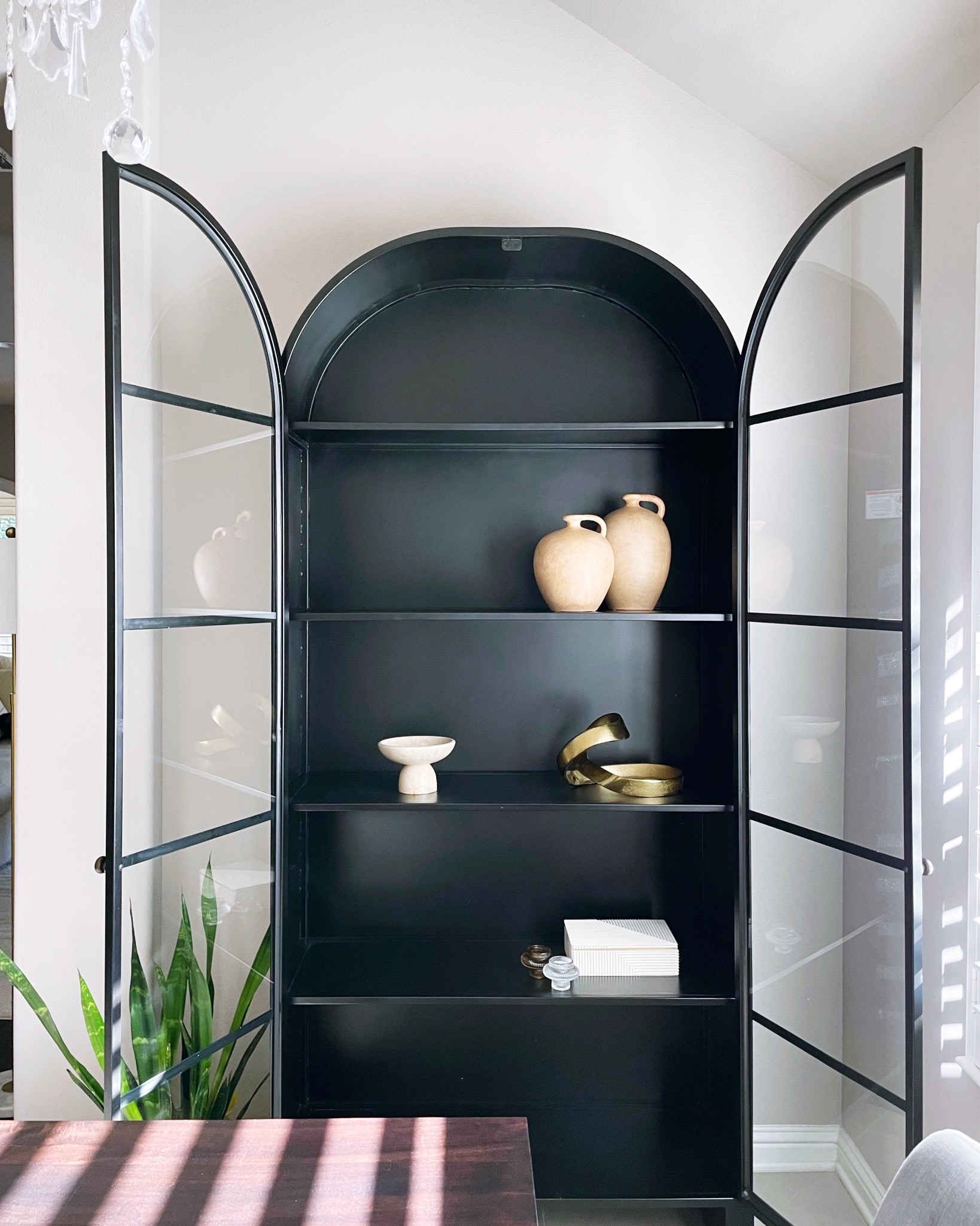 {#home} something bittersweet about adding that last piece of furniture after 5 years of living here (time flies)!! i love how each piece has a story to it & makes a house a home 🏡 💕🙏 #grateful // this cabinet is 87” high, made of black iron and glass front doors. i love the simplicity and arch that still gives it a modern look 🤩 can’t wait to completely style the shelves 🤓 // shop this post via #linkinbio ✌️ {10.23.22} 

#LTKunder100 #LTKhome