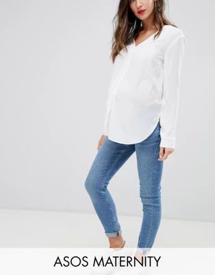 ASOS DESIGN Maternity high rise ridley 'skinny' jeans in pretty mid stonewash blue with under the... | ASOS (Global)