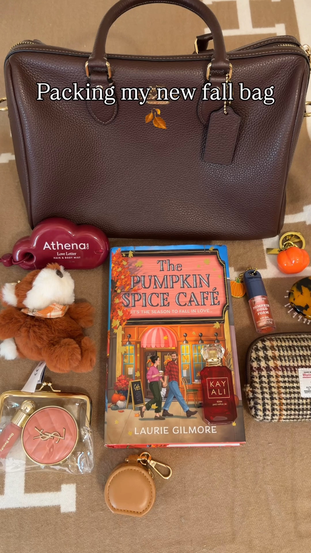 What’s in my bag 🍂 Fall Edition 🍂 what fits in the large maple Rowan 🍂 Comment SHOP & I’ll dm you the links 🤎

Pumpkin spice cafe fall book
Harris tweed pouch KayAli mini apple perfume
Bath and body works pumpkin cold foam lip oil
Fall bandaids
Rare beauty mini blush
YSL mini blush
Personalized hairbrush form Etsy
Clear kisslock pouch
Mini jewelry pouch
Reusable lint roller ball
Athena hair and body mist from target 
Mini blender
Pumpkin pouch charm for AirPods
AirPods chain
Fox bag charm from American eagle 
Coach bags chain