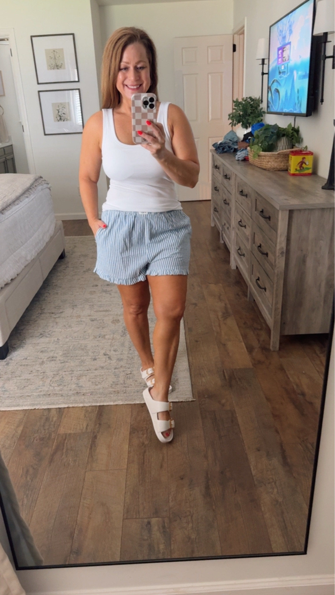 Casual summer outfit 
Ruffle trim shorts with pockets 
Come in stripe or gingham plaid
Multiple colors
Tank with built in bra 

The shorts are perfect  for lounging, casual outfit or as a swim coverup

#LTKootd #LTKSeasonal #LTKPetite