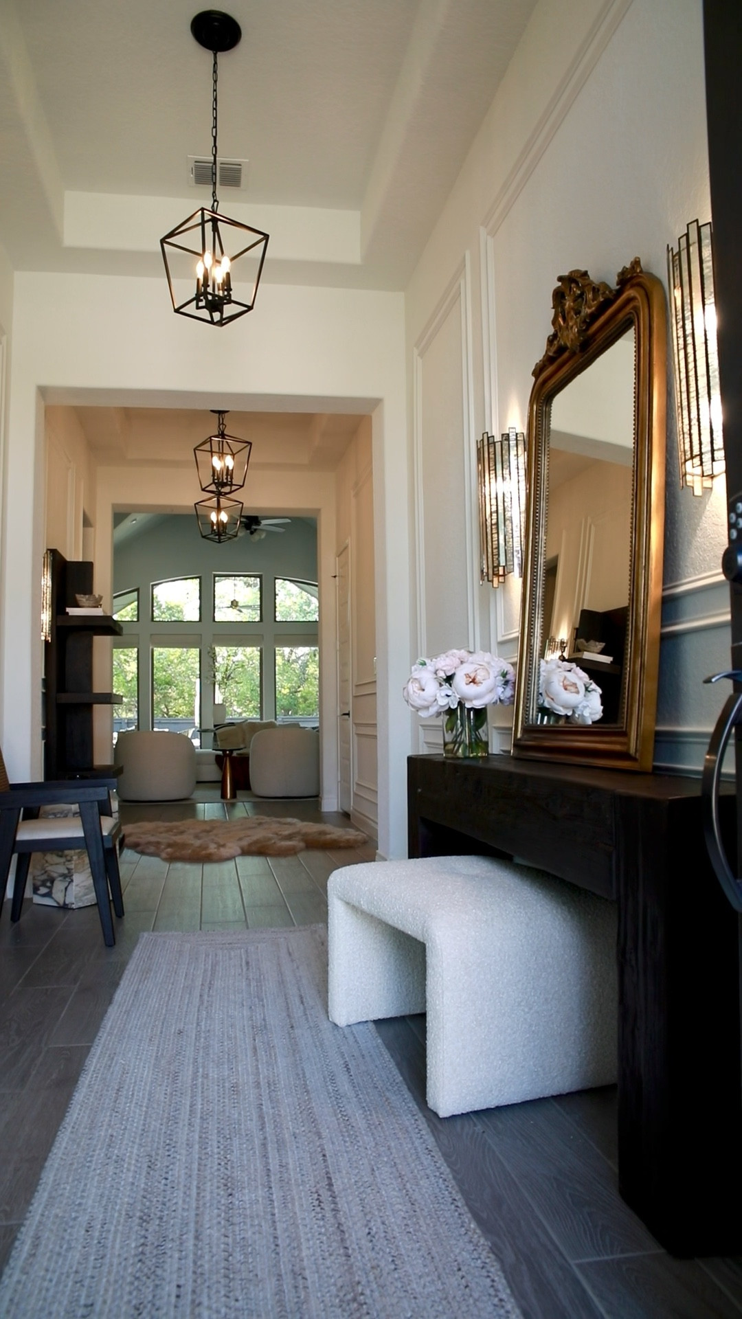 My Foyer reveal with Arhaus! 
 Details 
✨Copenhagen Wall Mirror  ✨78” Ubud Console in Shou Sugi Ban  ✨20” Garnet Pendant in Black  ✨Leandro Bookcase in Ebony  ✨Sansa Braided Performance Rug in Grey  ✨ Wool Rug in Linen  ✨Laila Wall Sconce  ✨Ryan Ottoman in Burbank Natural  ✨Kroy Cane Back DIning Arm Chair with Linen Natural Fabric 

#LTKFind 

#LTKhome