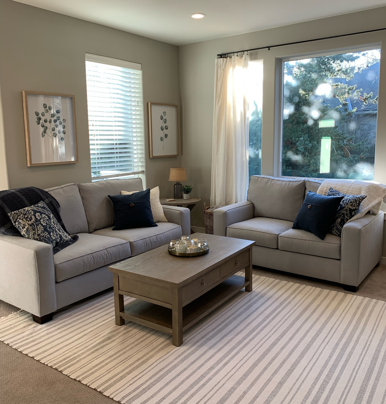 Living room makeover, family room decor, couch sofa coffee table living room, gray couch blue blanket throw pillows, light and airy living room, coastal blue farmhouse living room, pottery Barn comfort square arm sofa couch and love seat, target hearth and hand gray stripe area rug.

#LTKhome #LTKfamily #LTKsalealert