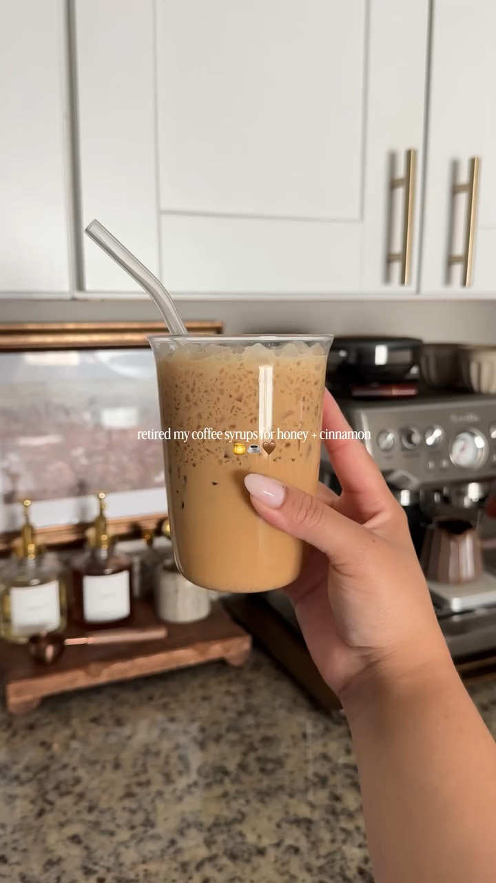 we have coffee at home!! 🍯☕️🤎 comment “shop” and i’ll send you links to my setup 🫶🏼 #coffee #coffeeathome #coffeebar #coffeestation #icedlatte 

coffee bar setup 
coffee station setup 
coffee at home 
iced latte at home 
iced latte recipe 
coffee recipe 
easy coffee recipe 
iced latte at home 
honey cinnamon latte 
coffee bar decor