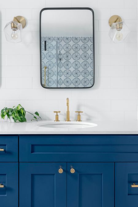 This kid’s bath is a fun and lively space that sparks joy and creativity. The shower wall is adorned with sunburst-shaped blue tiles, adding a touch of whimsy and energy. #subwaytile #bluebathroom #kidsbath #kidsbathroom #moroccanthemebath #moroccaninspireddesign #interiordesign #brassfixtures

#LTKHome