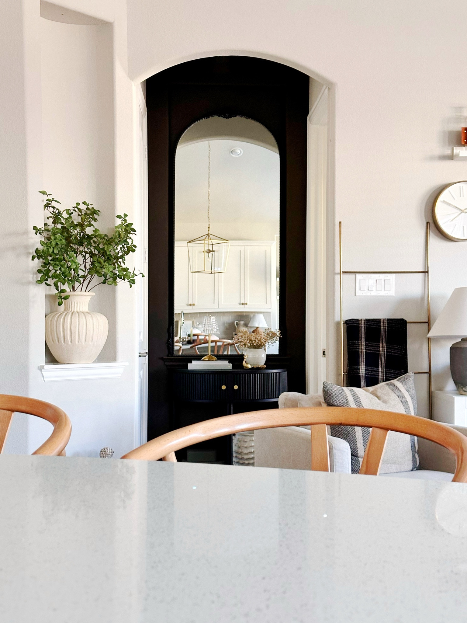 Loving how accenting this wall with a mirror and dark paint has created a focal point in our open living are! 

#LTKhome #LTKSpringSale