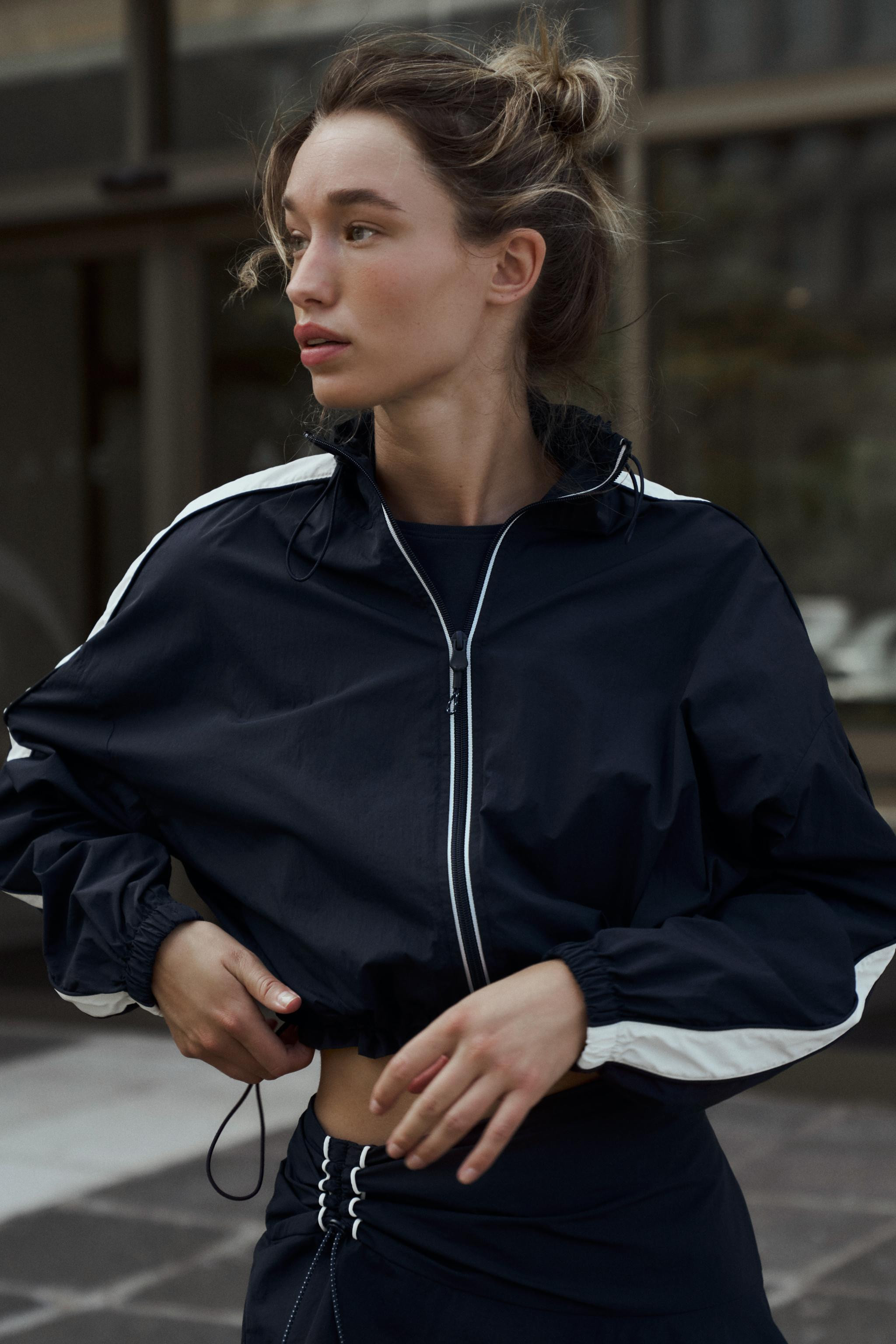 High collar, long sleeve jacket with contrasting side stripes. Elastic trim details. Front zip cl... | Zara US